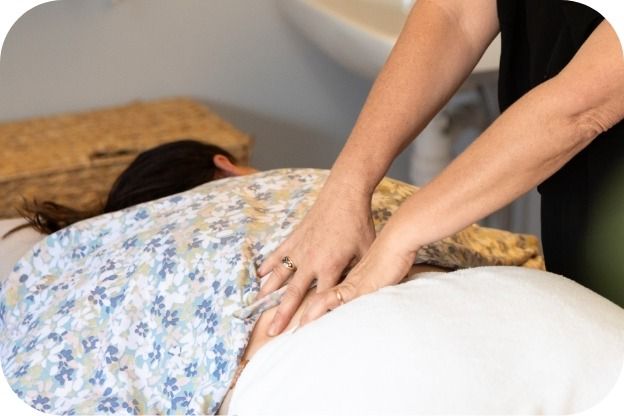 A Woman is Laying on a Bed Getting a Massage β Your Body Revolution in Caloundra, QLD