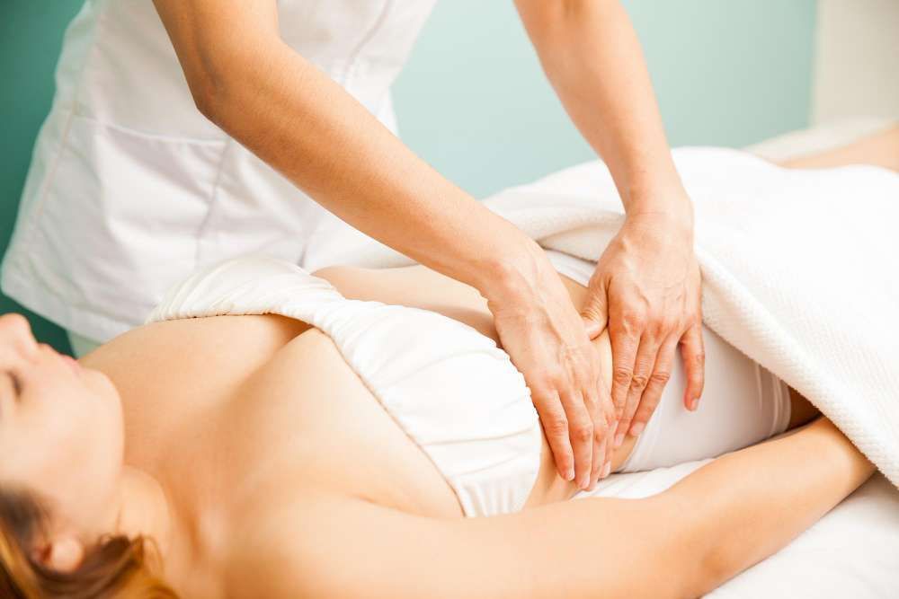 A Woman is Getting a Massage on Her Stomach in a Spa — Your Body Revolution in Caloundra, QLD