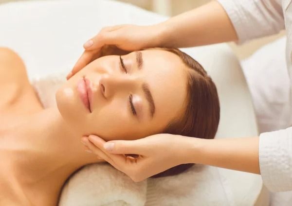 A Woman is Getting a Head Massage at a Spa — Your Body Revolution in Caloundra, QLD