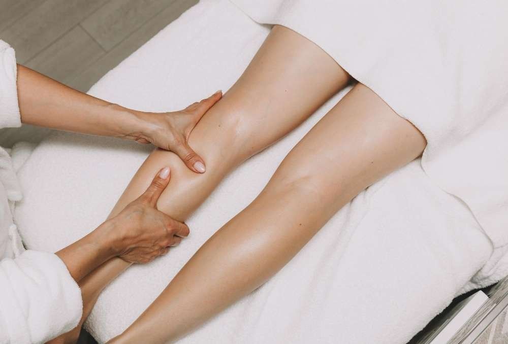 A Woman is Getting a Leg Massage at a Spa — Your Body Revolution in Caloundra, QLD