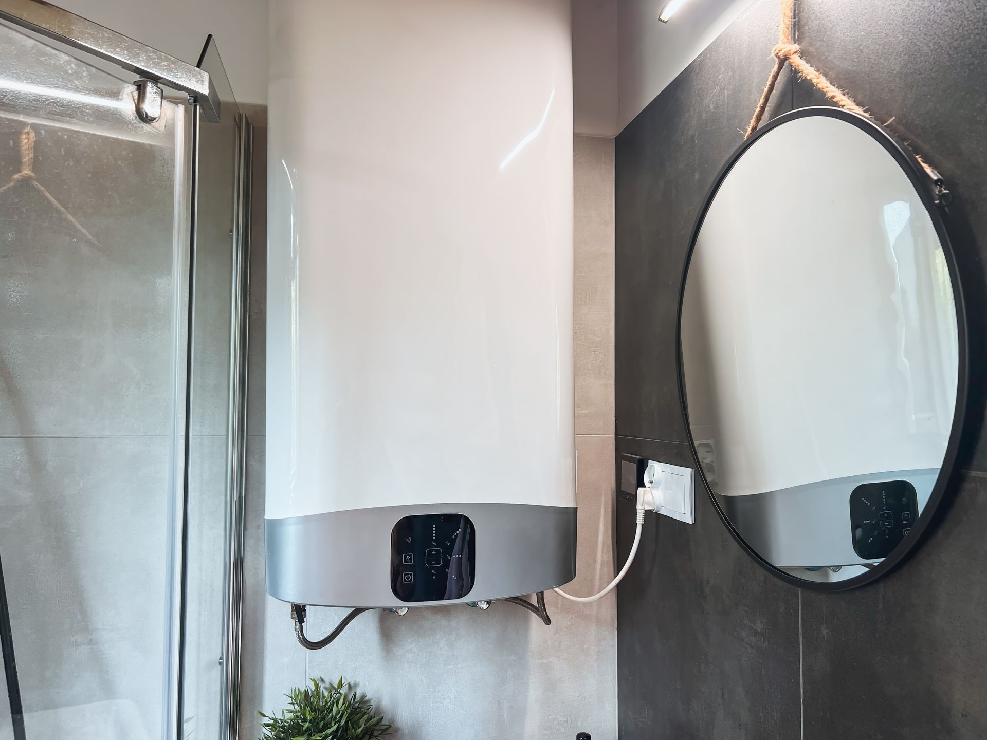 A bathroom with a water heater and a round mirror