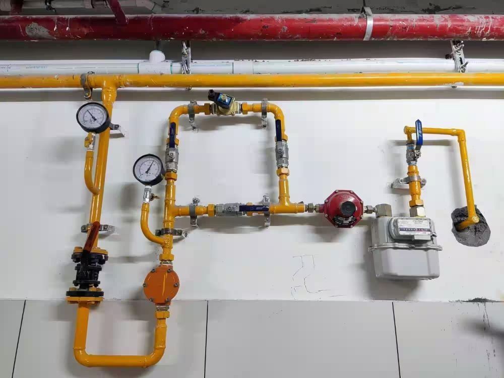 A man is working on a pipe with a wrench.