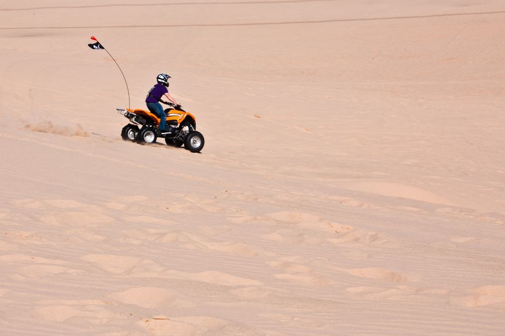 a person on an atv in the desert