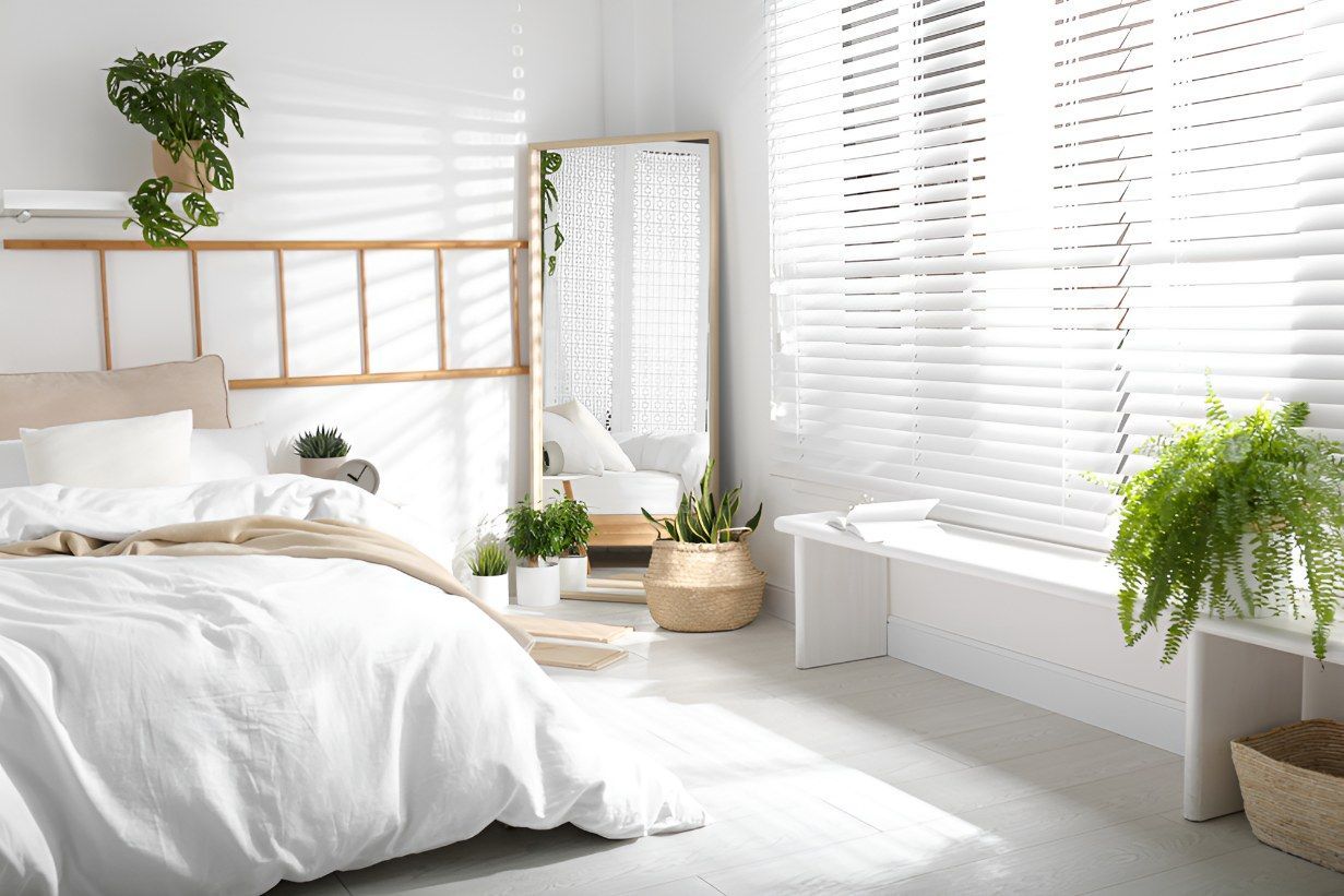 A Bedroom With A Bed, Mirror, Plants And Blinds — K & S Windows In Ciccone, NT