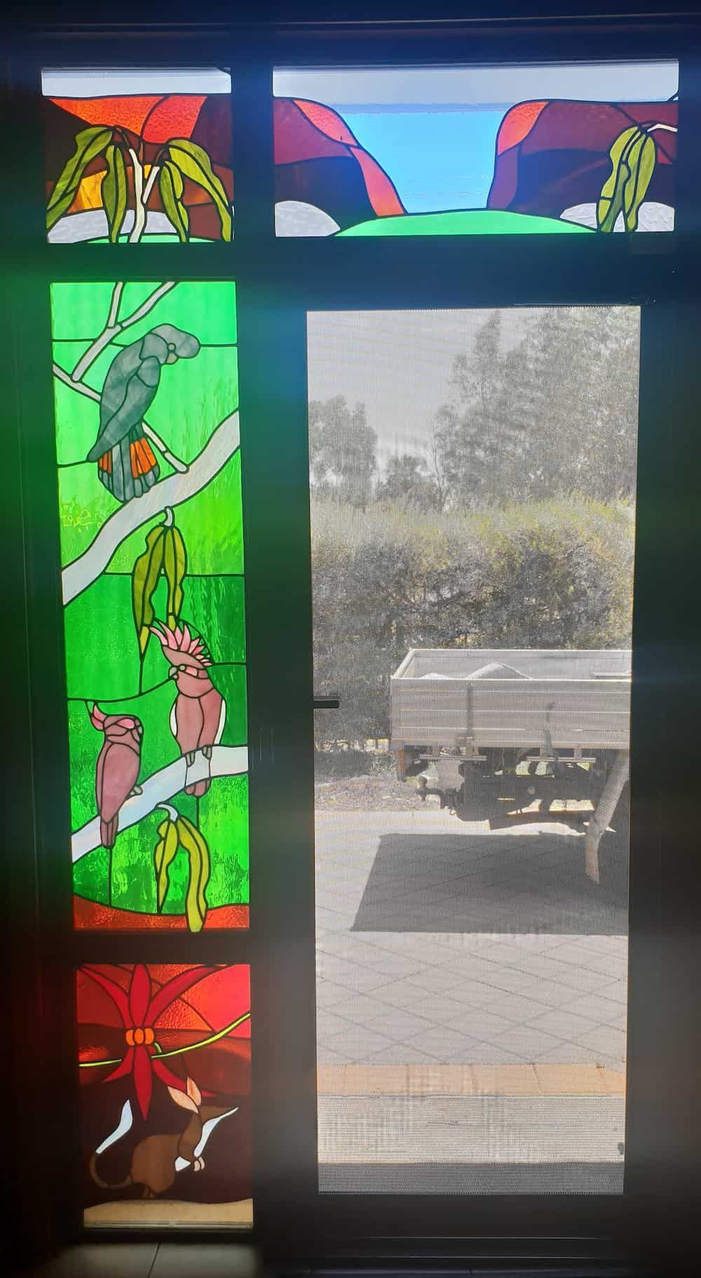 A Stained Glass Window With A Truck In The Background — K & S Windows In Ciccone, NT