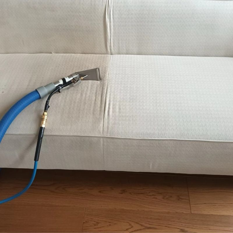 A black and white photo of a vacuum cleaner cleaning a carpet