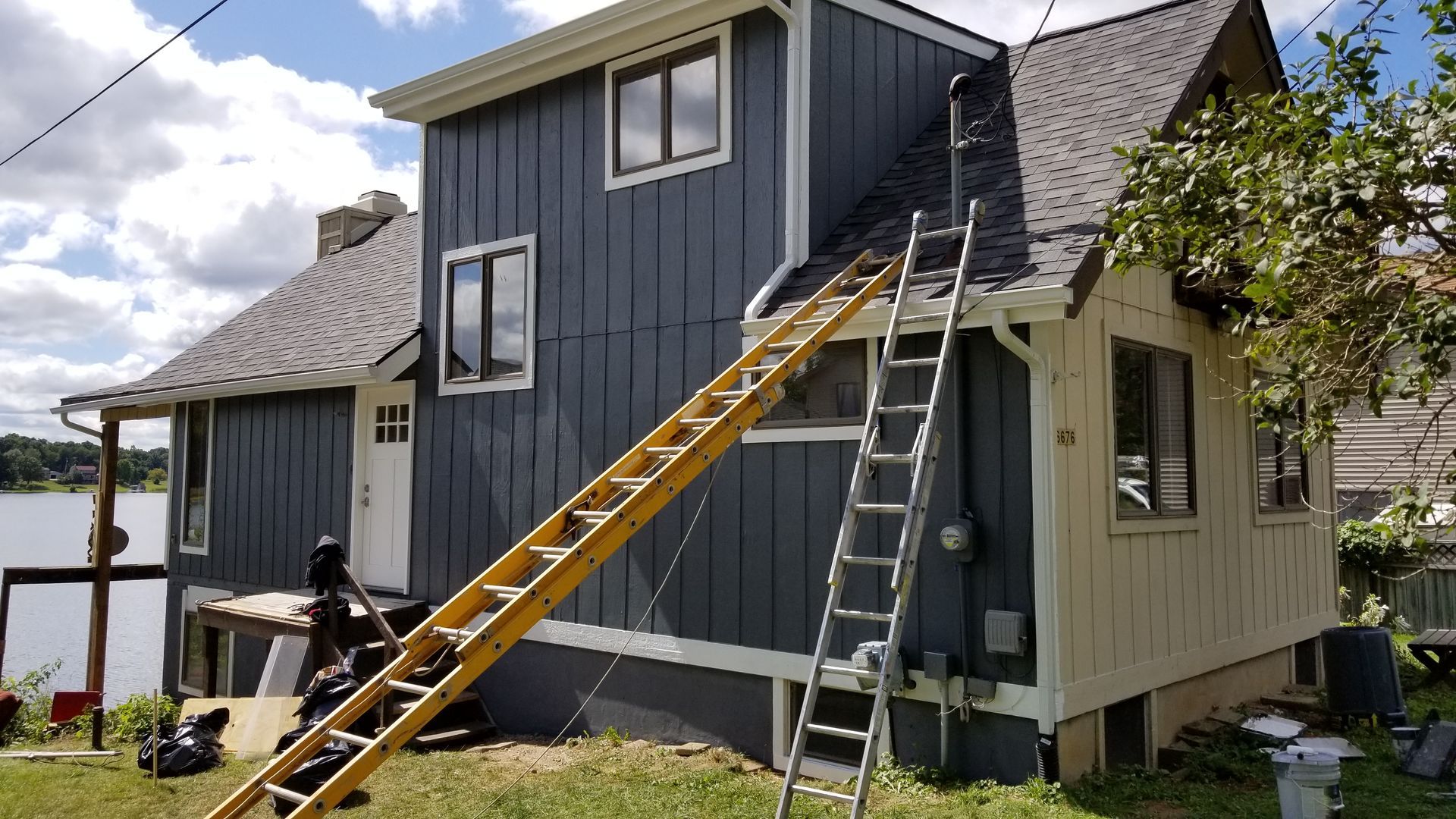 A ladder is leaning against the side of a house.