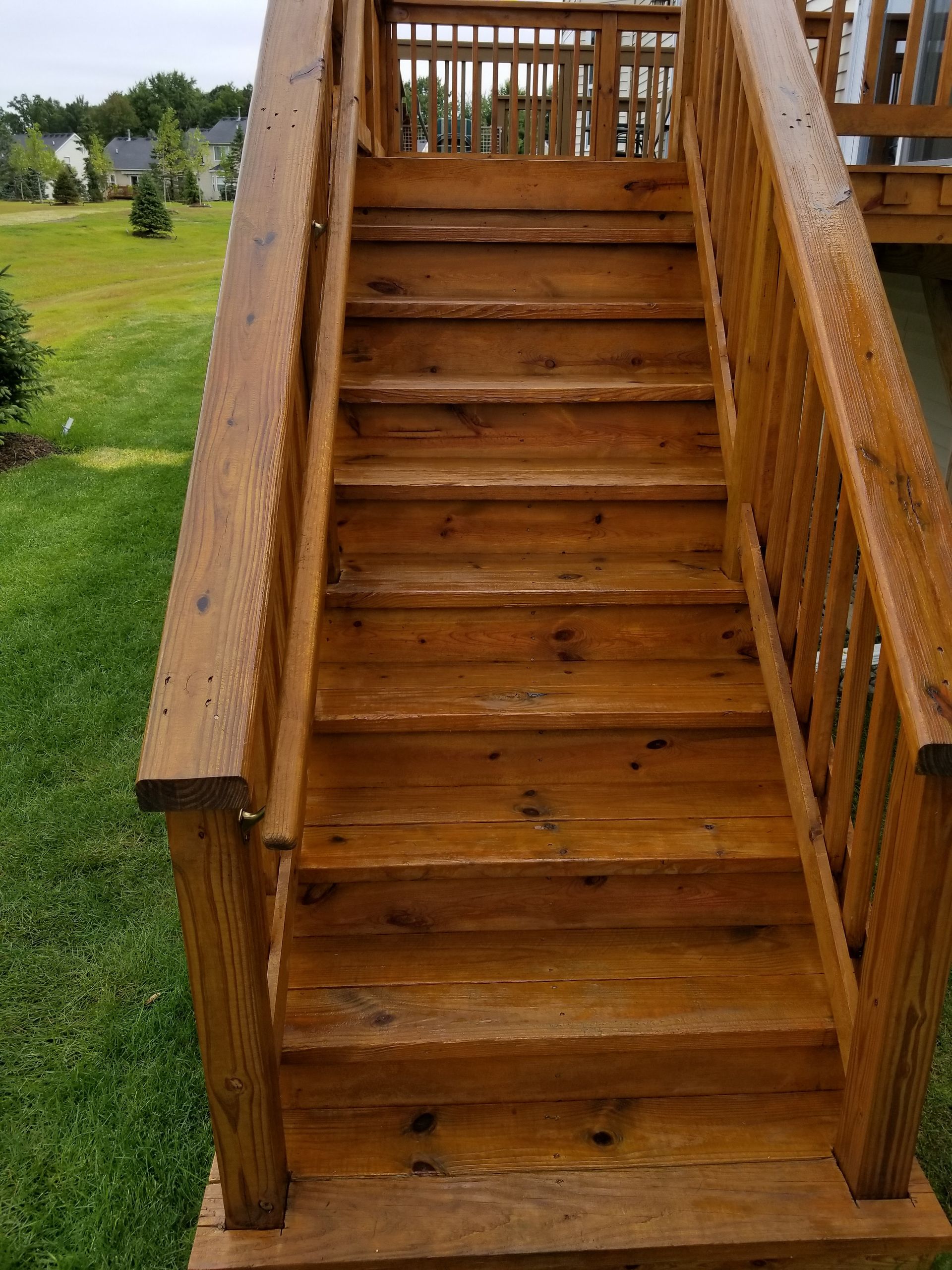 A wooden deck with stairs leading up to it.