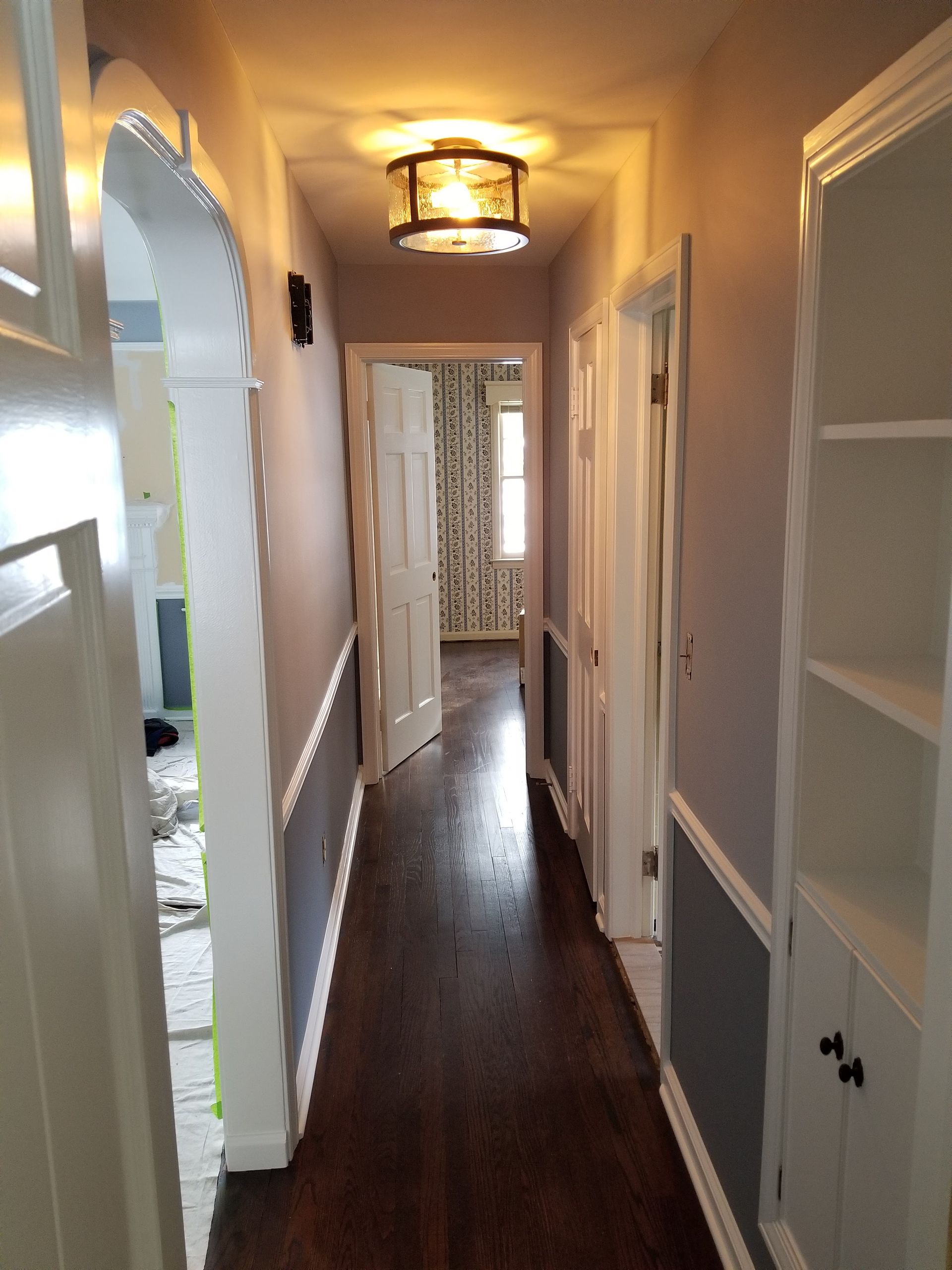 A long hallway with a light on the ceiling