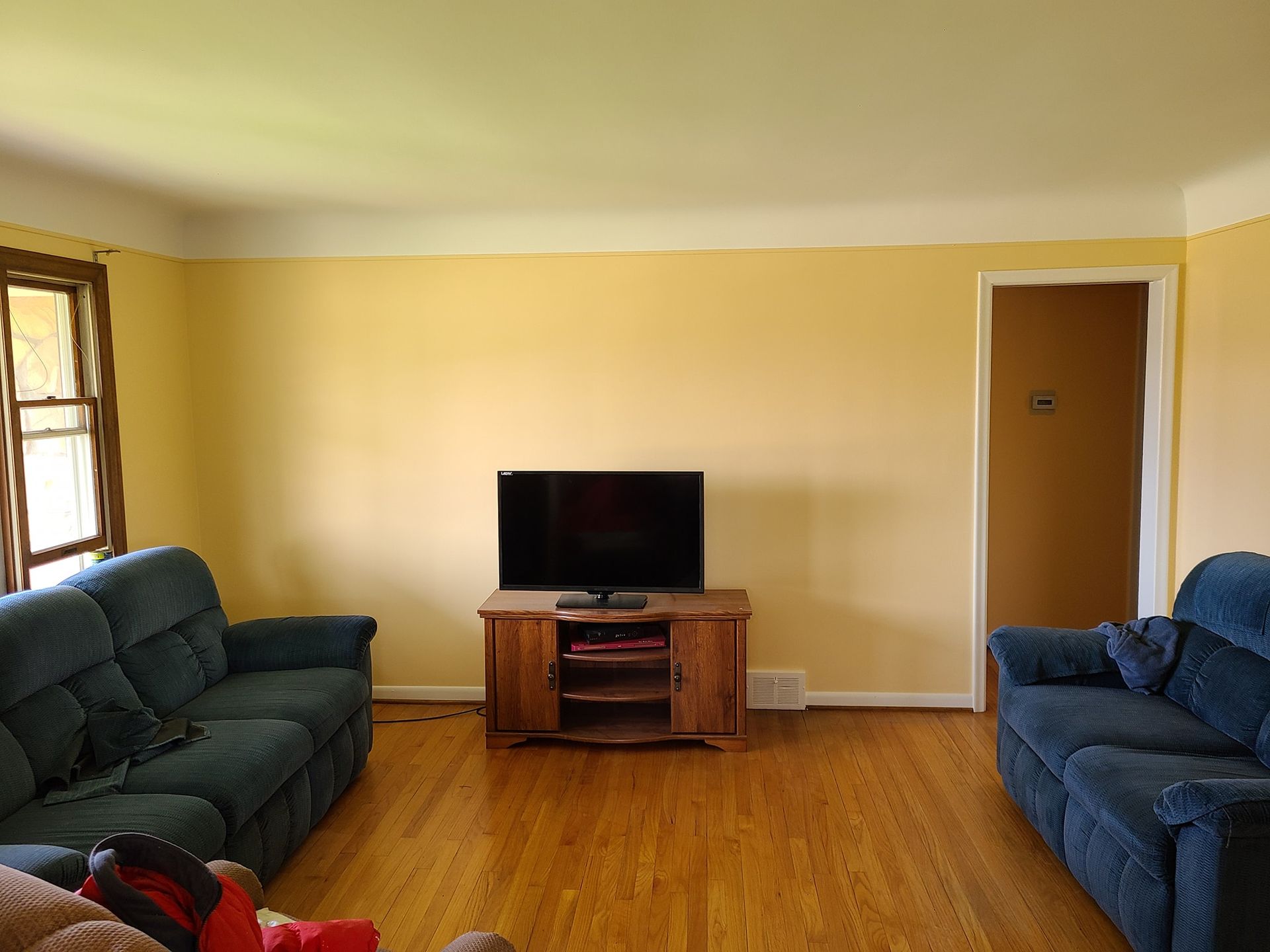 A living room with two couches and a flat screen tv.