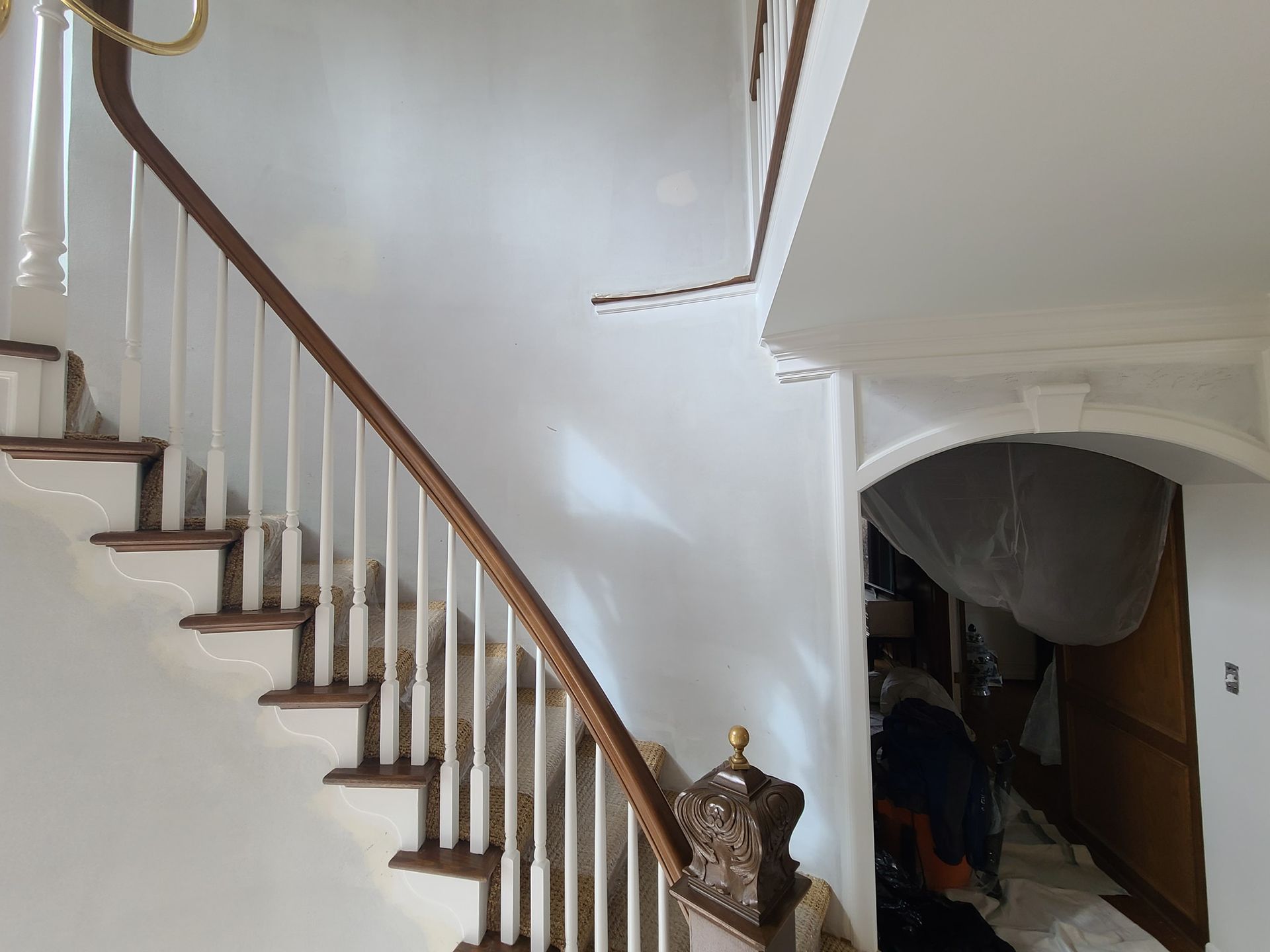A man is working on a staircase in a house