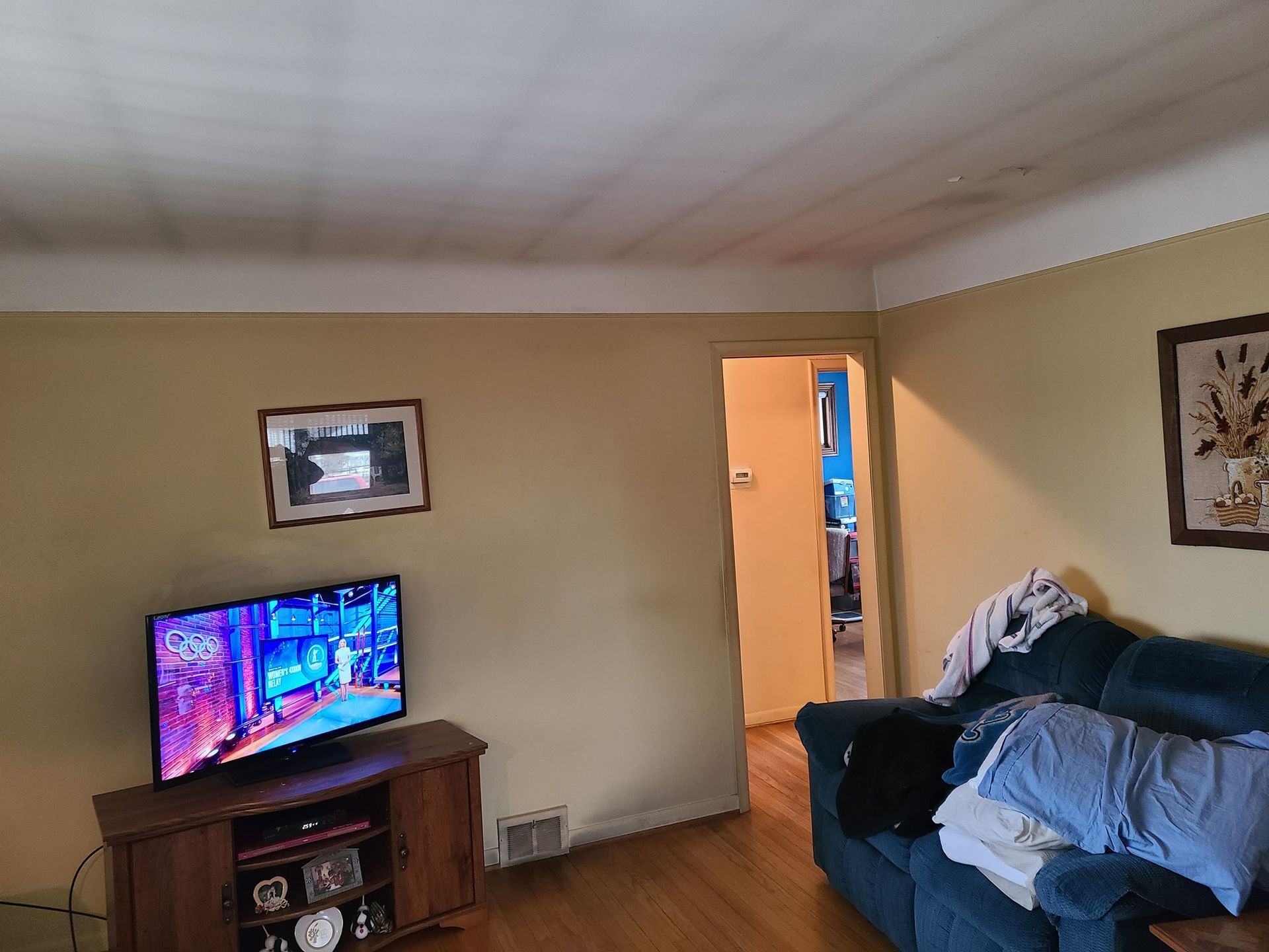A living room with a couch and a flat screen tv.