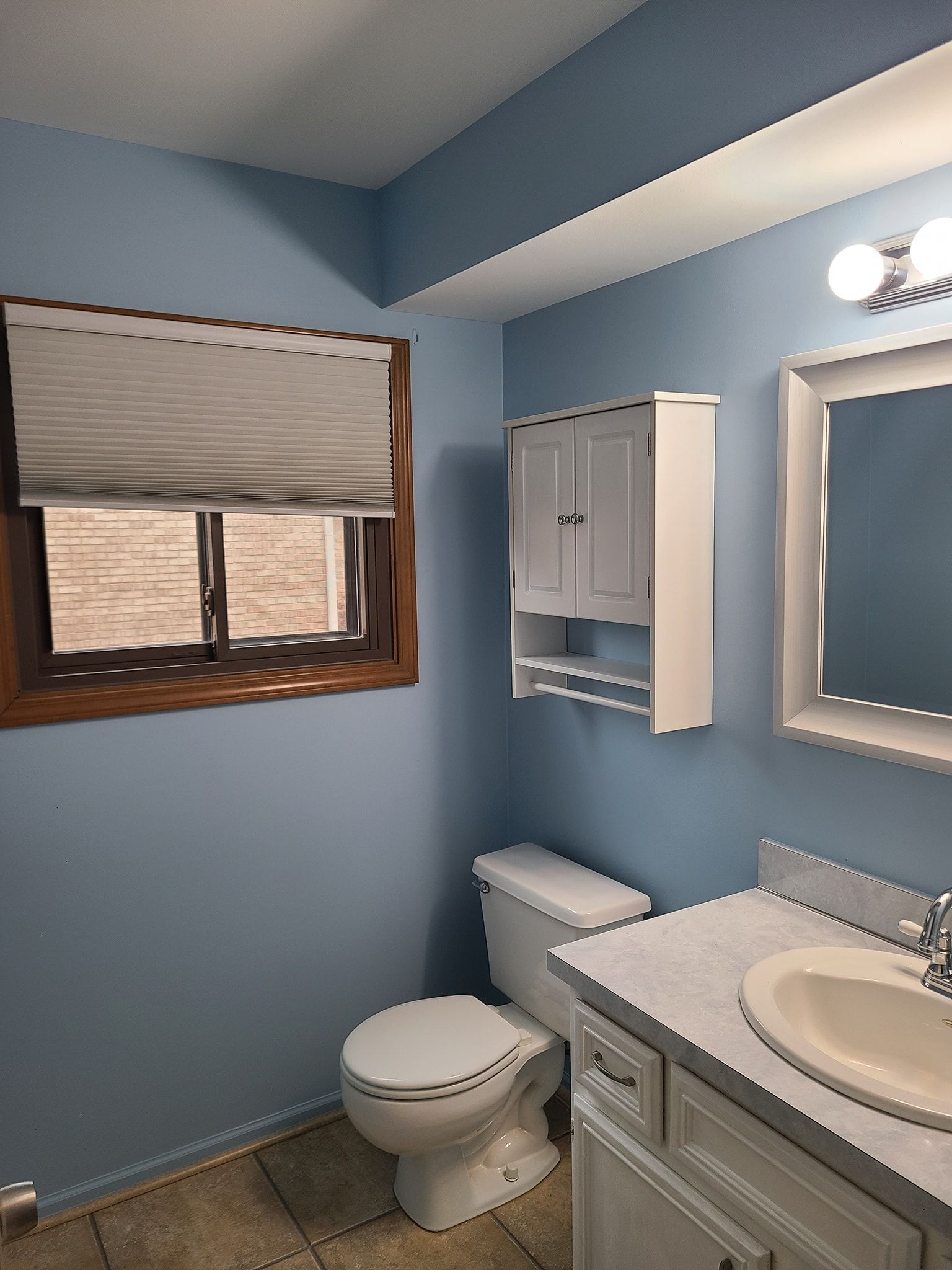 A bedroom with white walls and a closet.