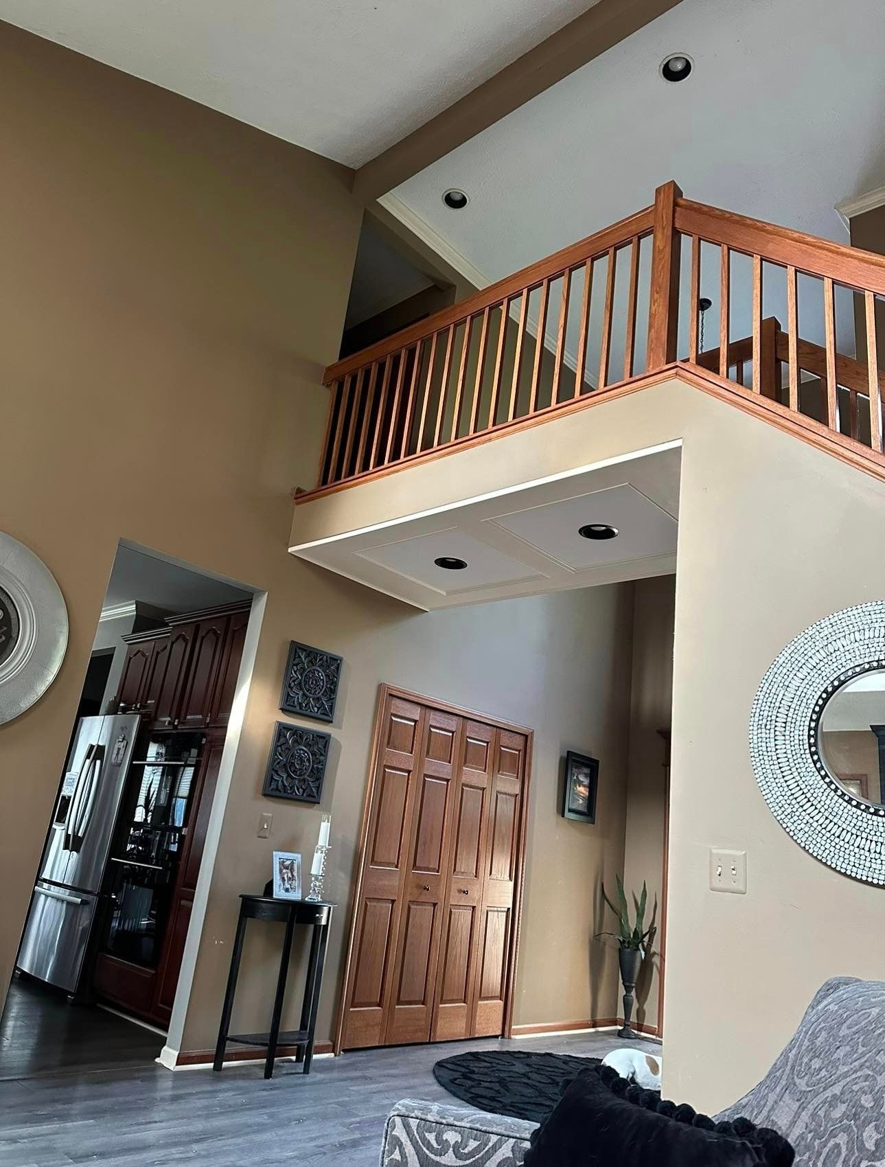 A living room with a staircase leading up to the second floor.