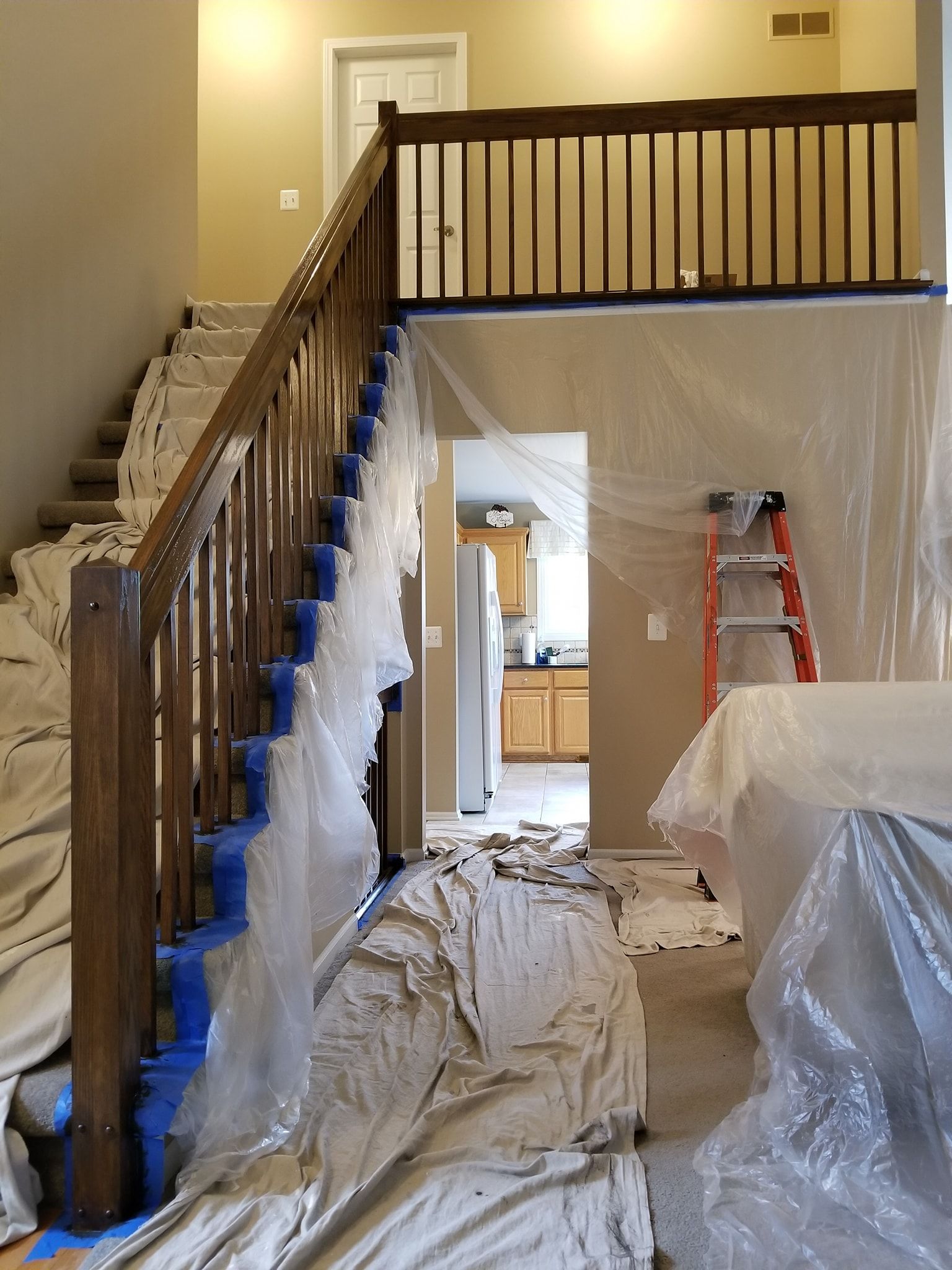 A staircase in a house that is being painted