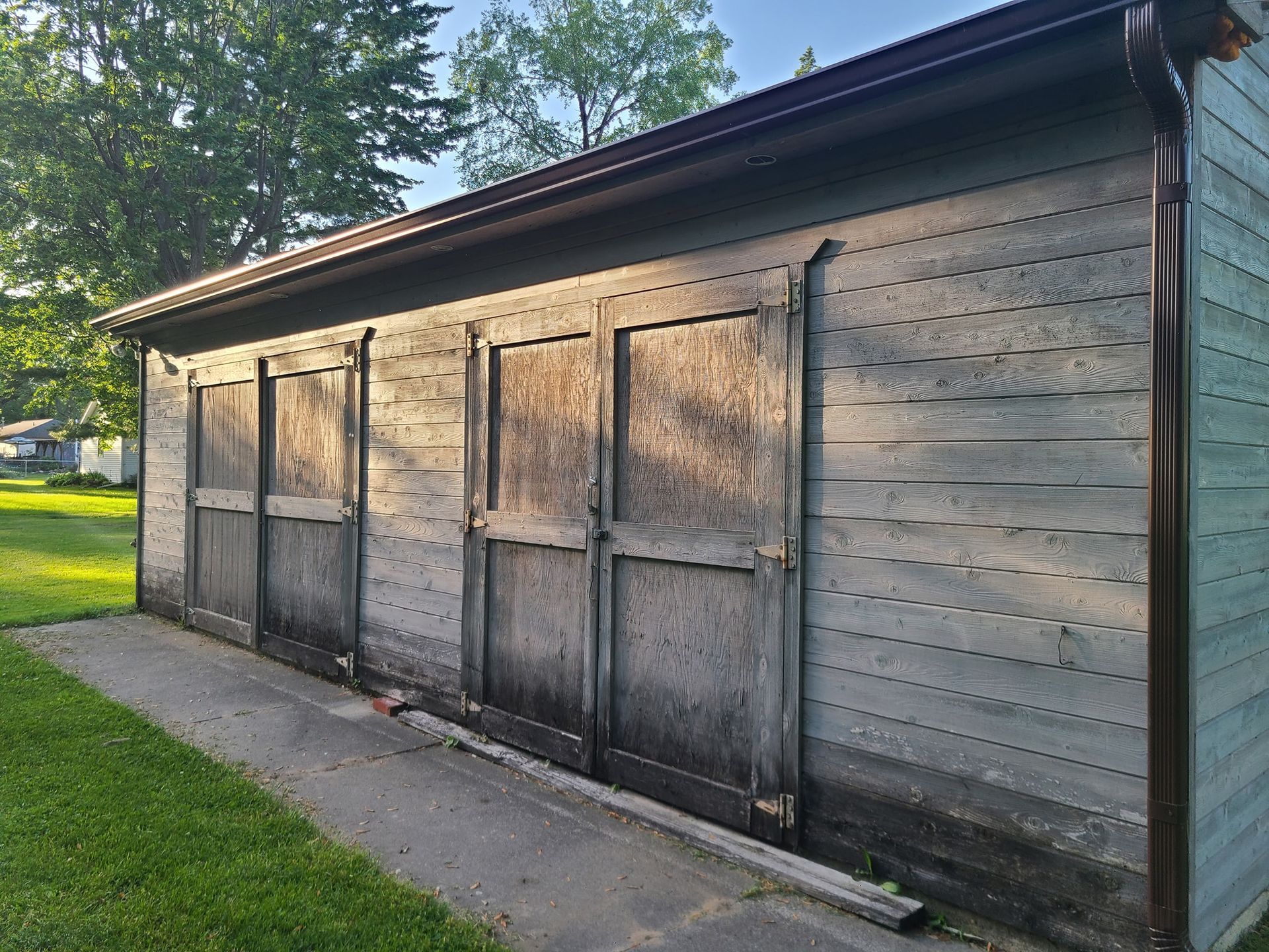 A row of wooden garage doors are lined up next to each other.