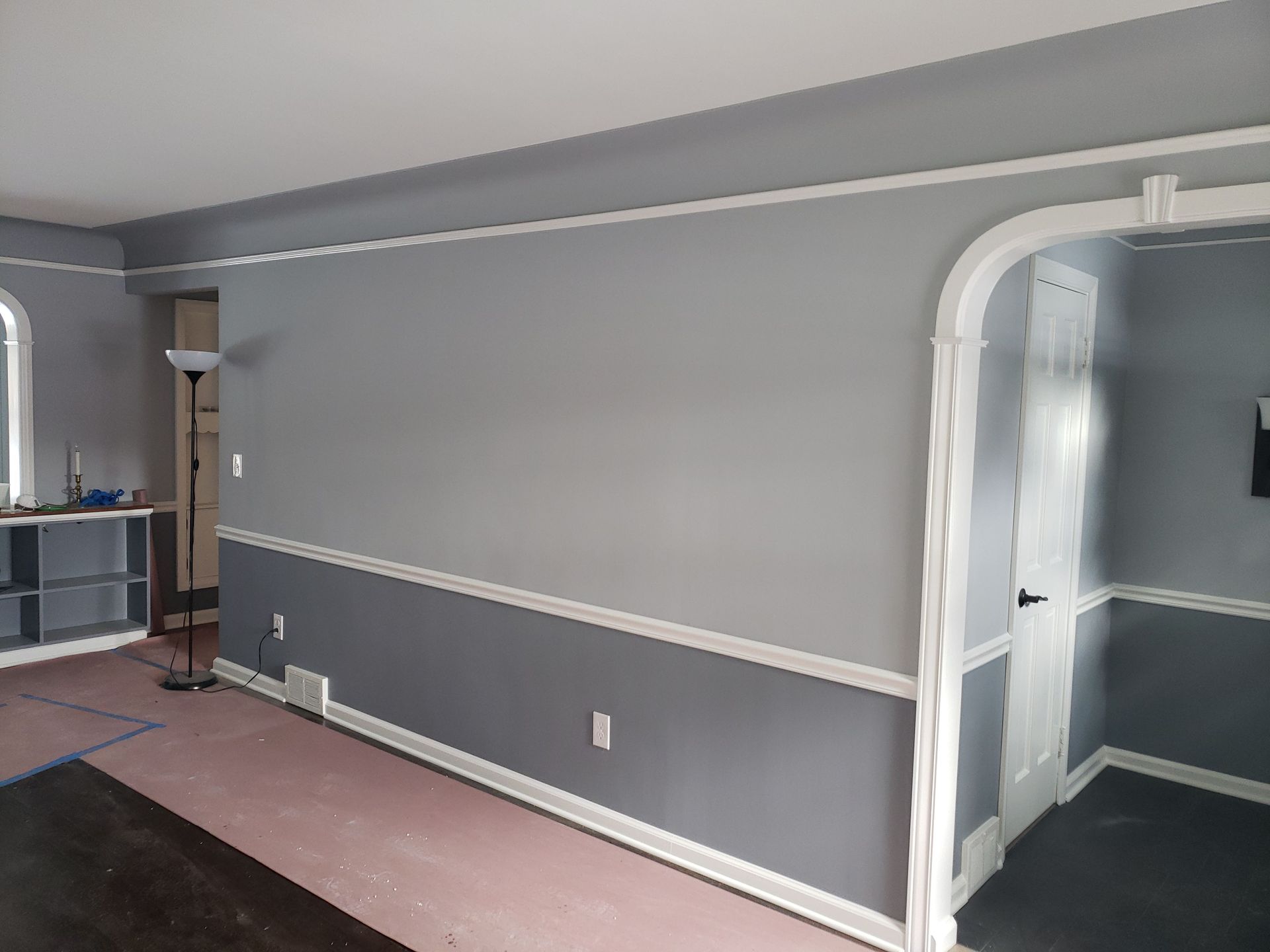 A living room with gray walls and white trim.