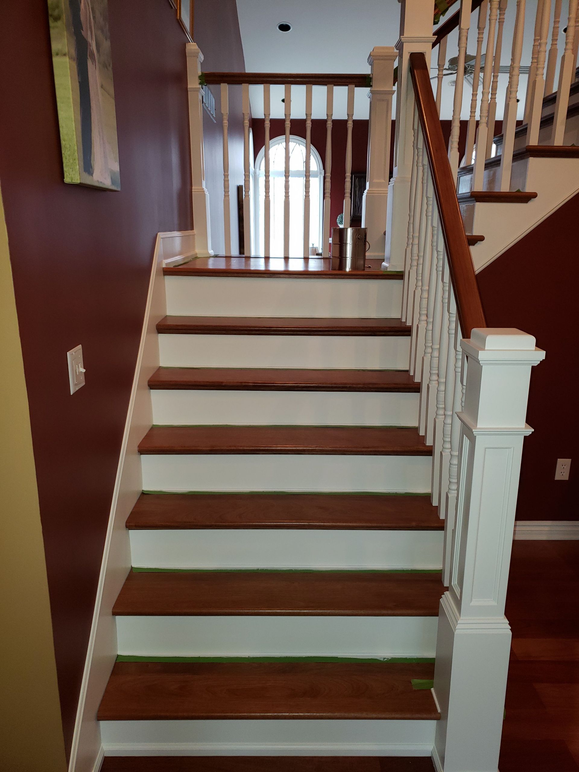 A staircase with wooden steps and a white railing