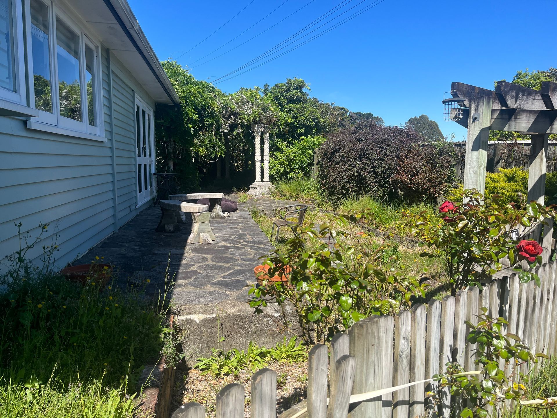A white house with a wooden fence in front of it.
