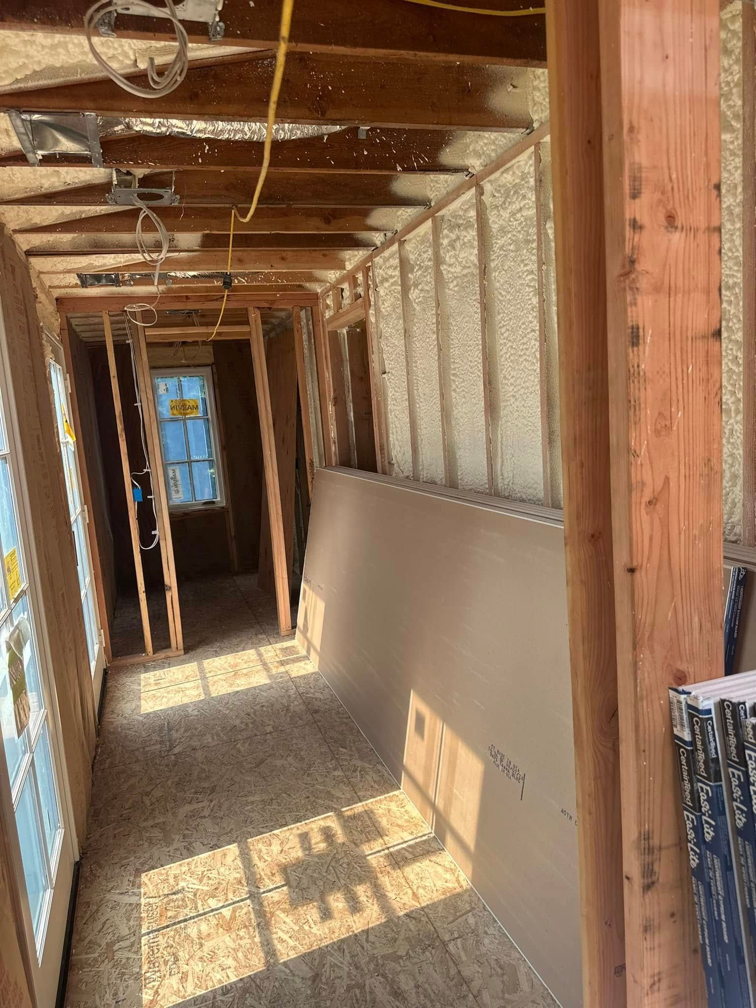 A hallway in a house under construction with a lot of insulation.