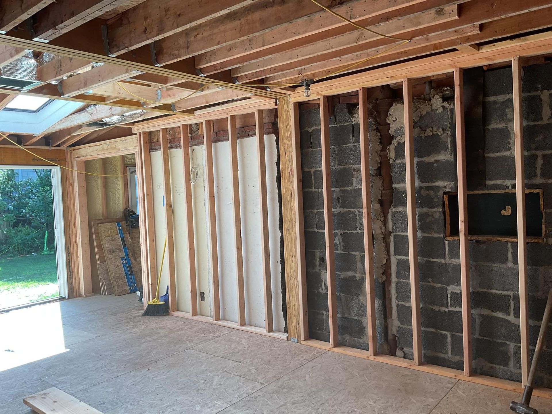 A room that is being built with brick walls and wooden beams