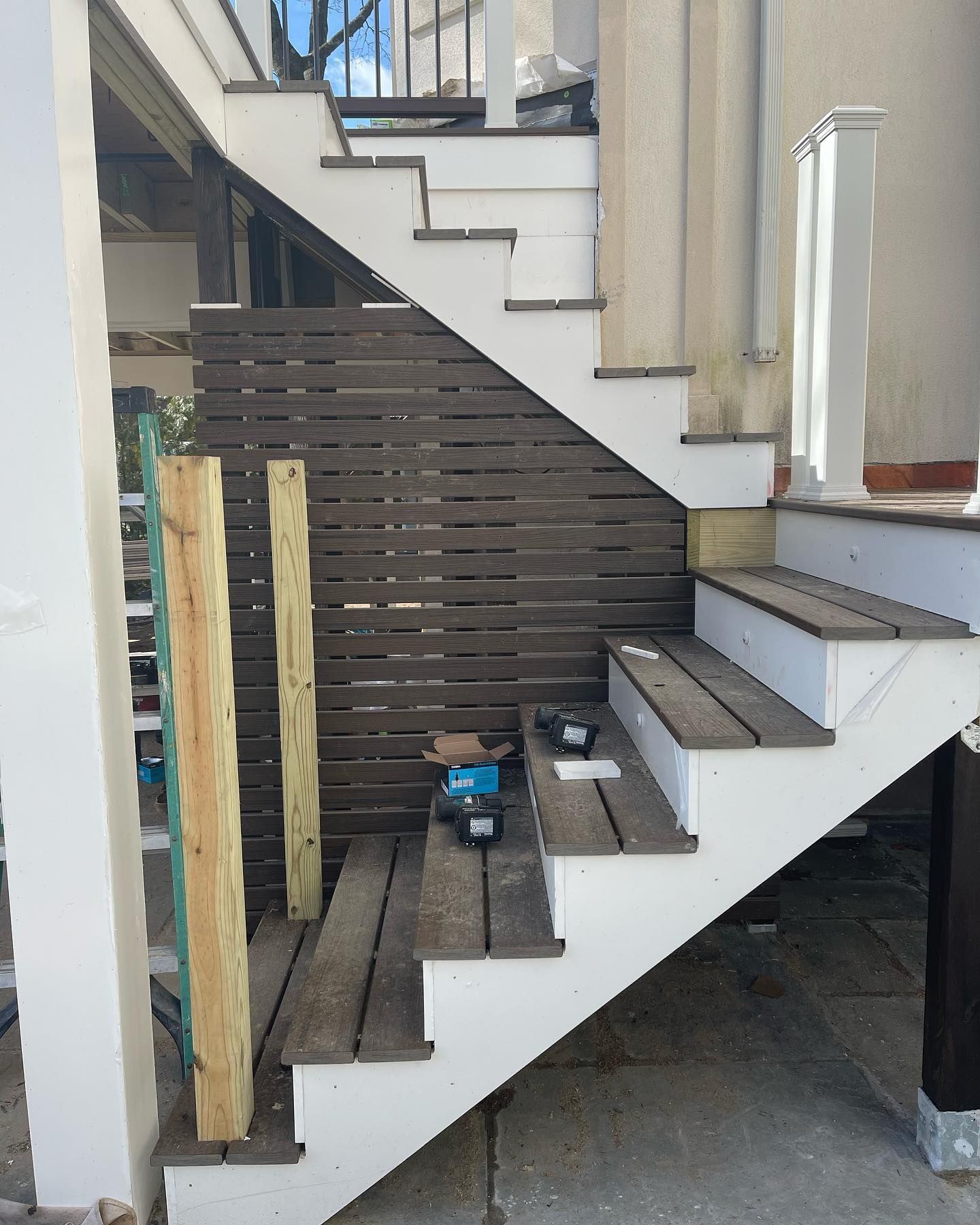 A white staircase with wooden steps and a wooden railing