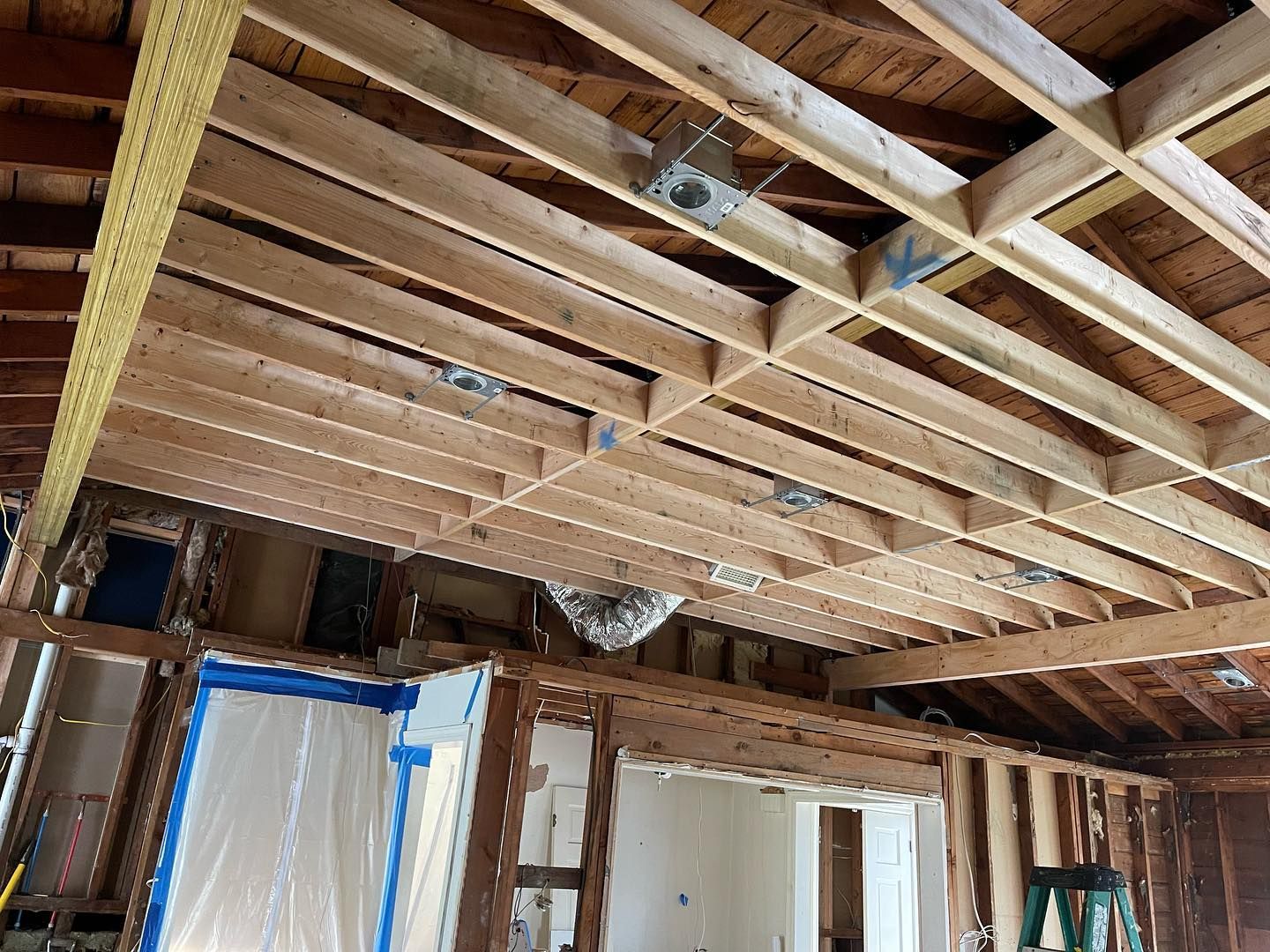 The ceiling of a house is being built with wooden beams.