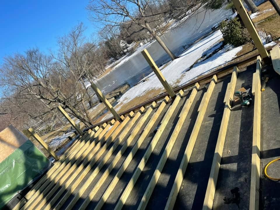 A roof is being built with wooden beams.