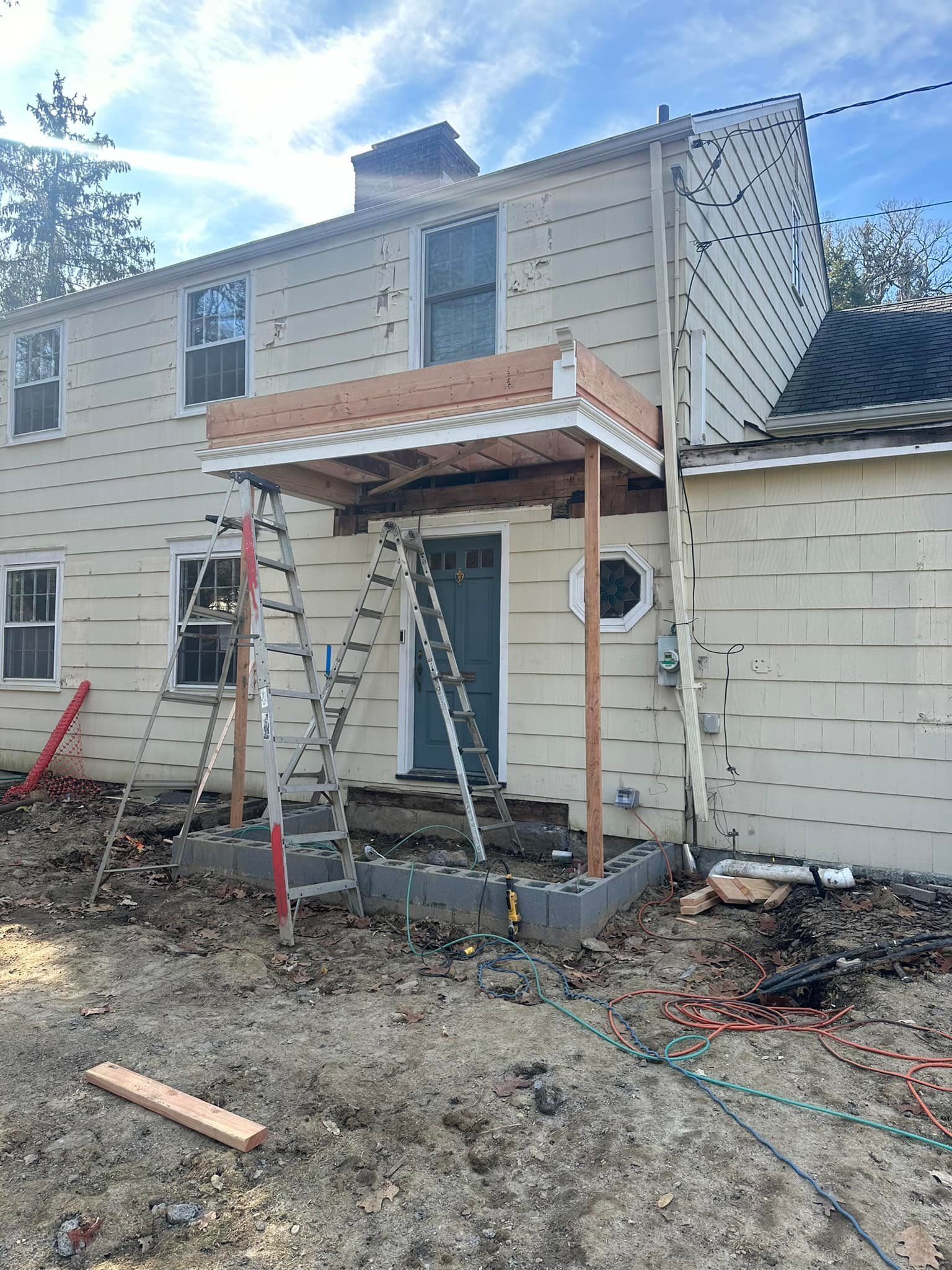 A house with a porch being built on top of it.