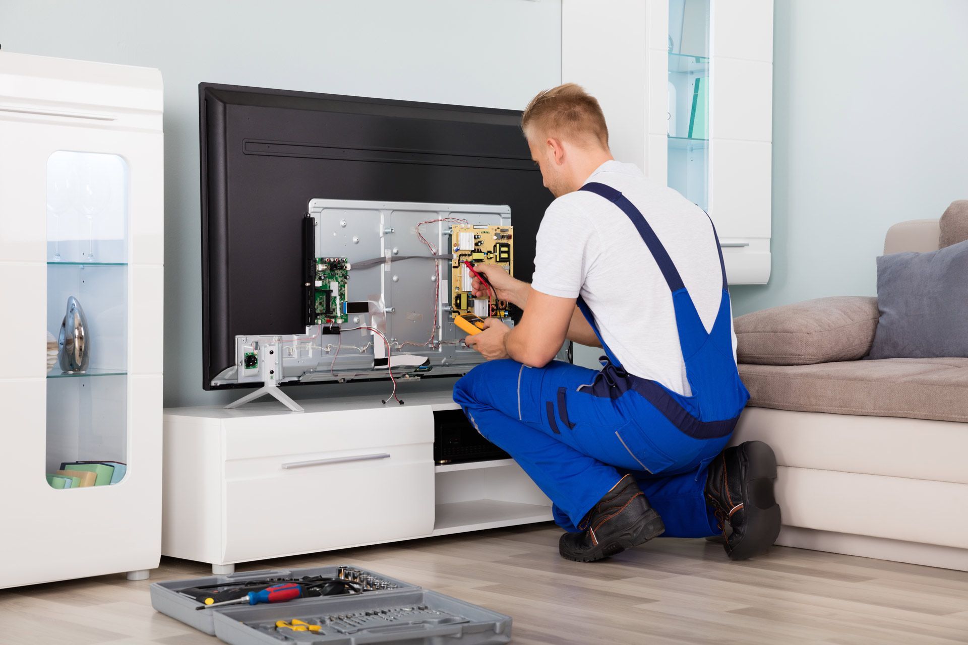 Young Male Electrician in Overall Checking Television | Mildura, Vic | a & R Electronics