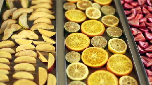 A tray of fruit including apples , oranges , lemons and strawberries.