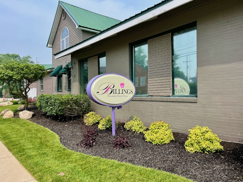 Billings salon building with sign, landscaping, and tinted windows.