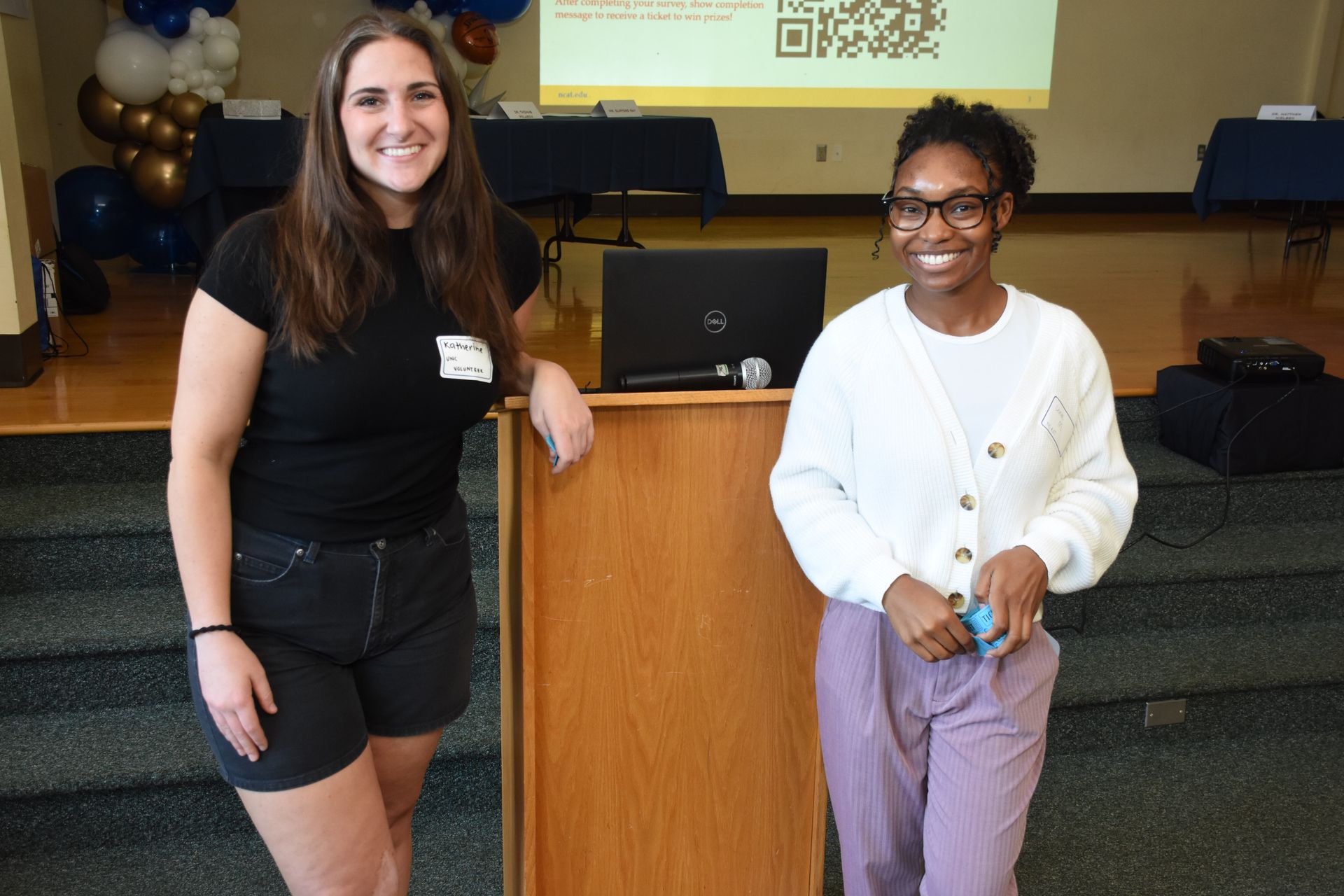 Two people standing by a podium