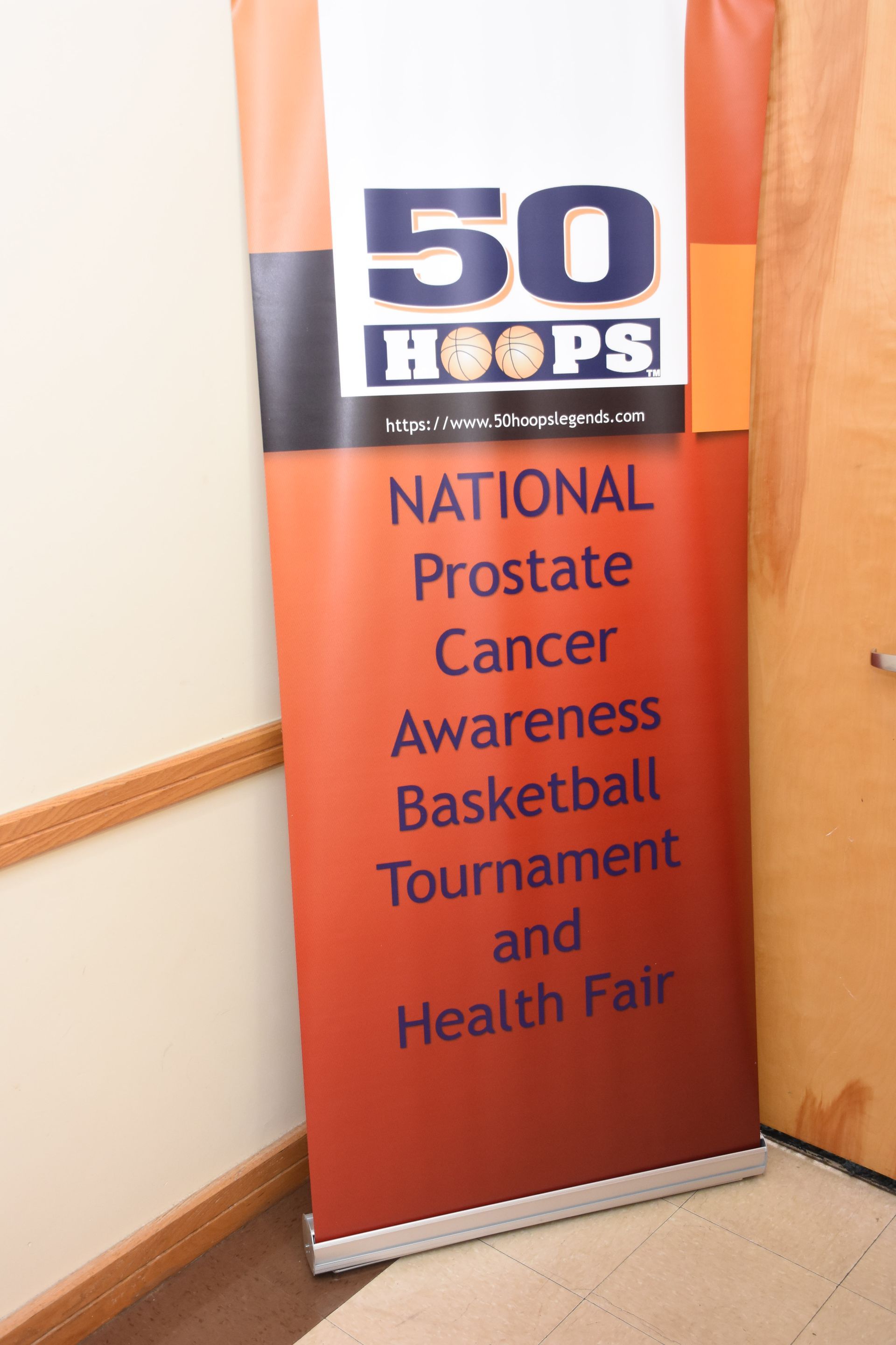 Banner for National Prostate Cancer Awareness Basketball Tournament and Health Fair, red and orange colors.