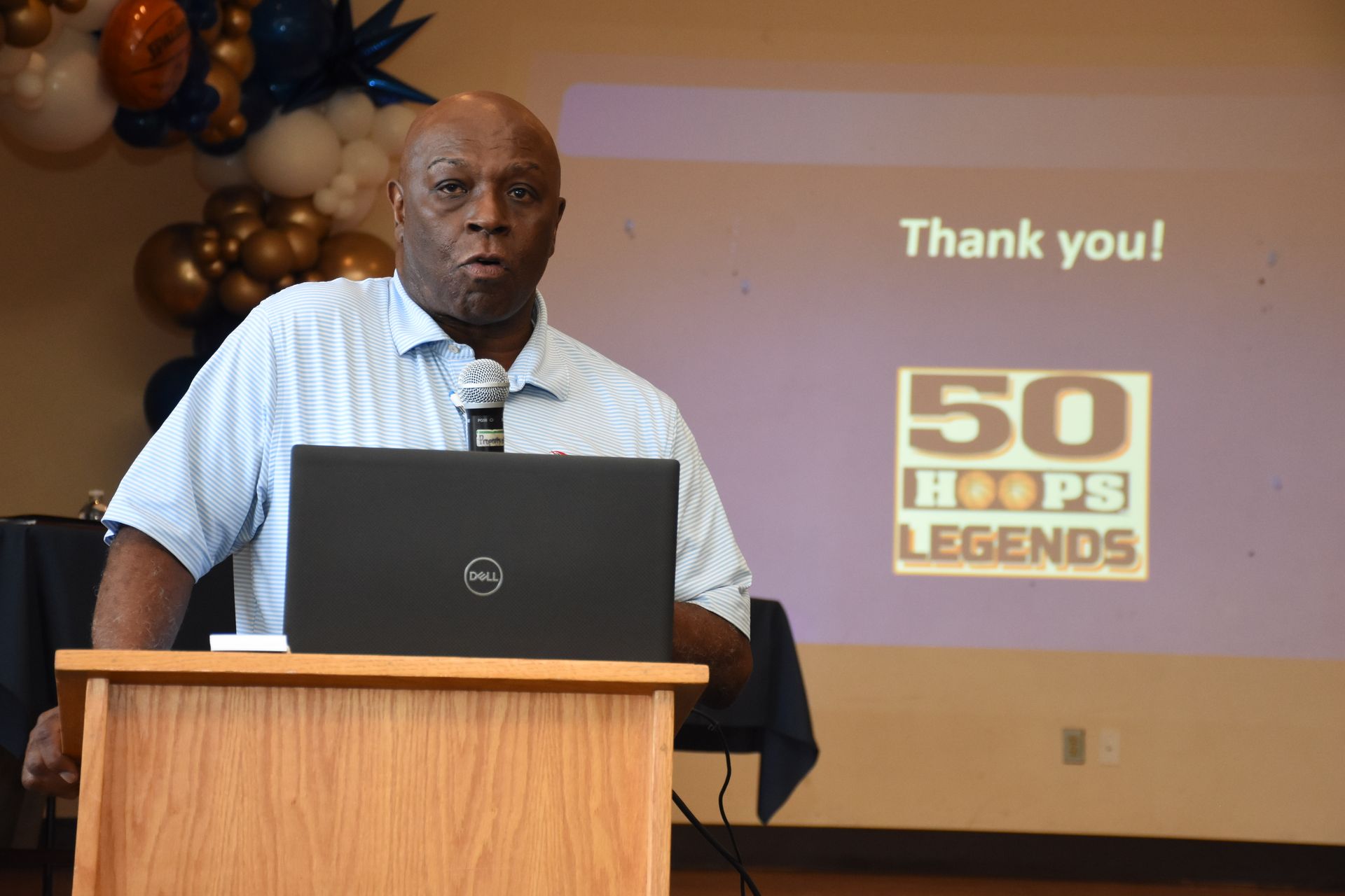 Man speaking at podium, 