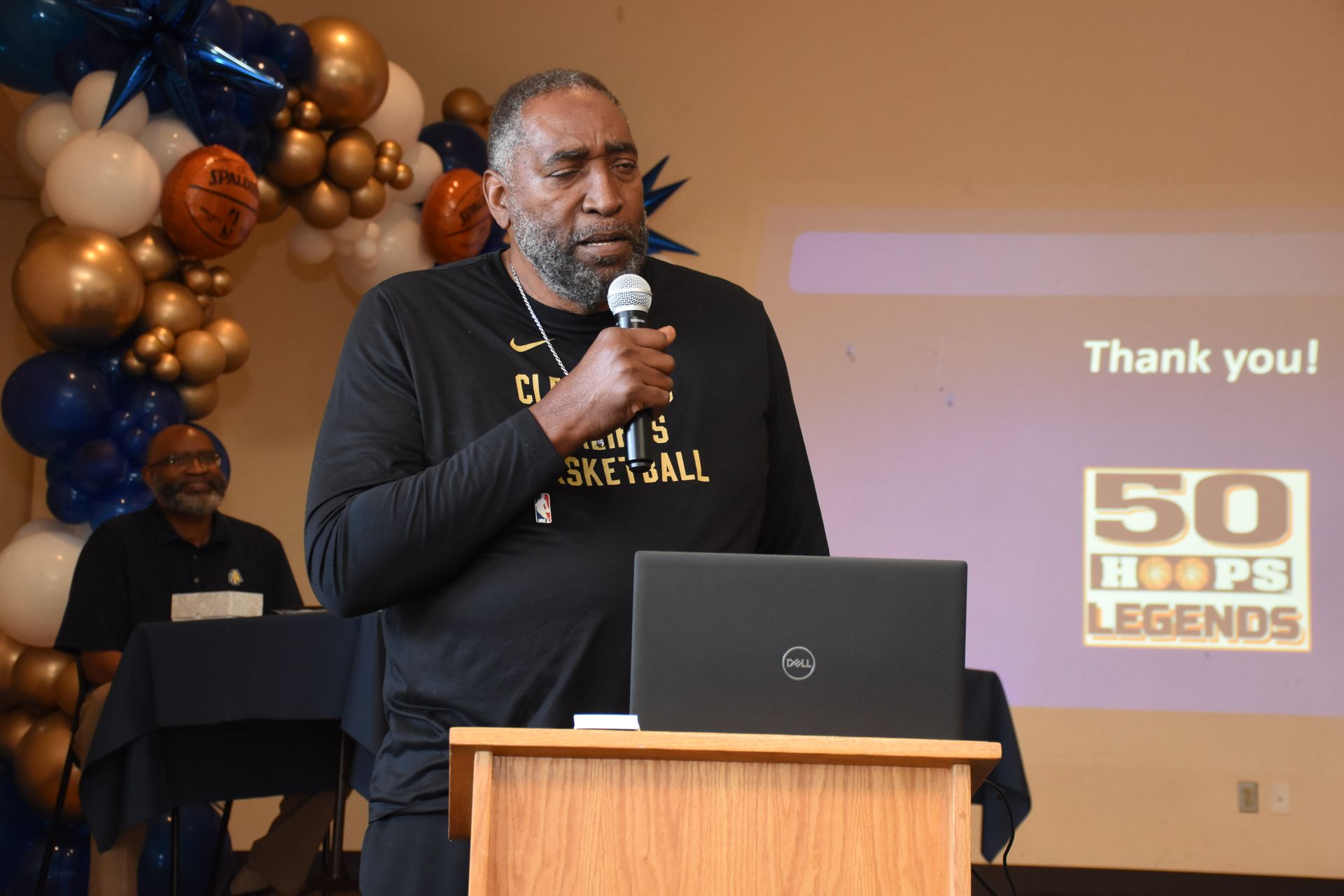 Man speaking at podium, 