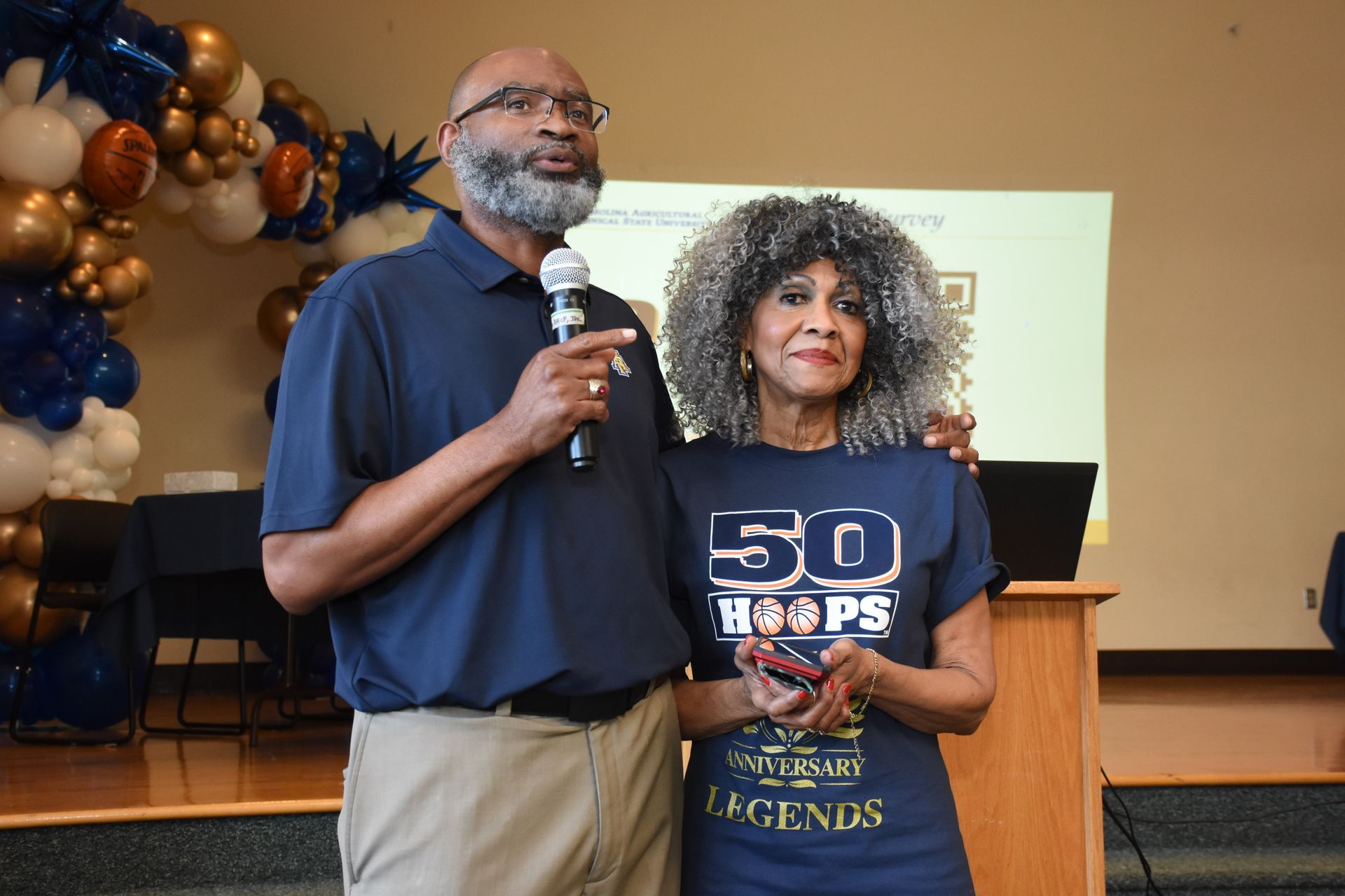 Man with microphone and woman wearing 