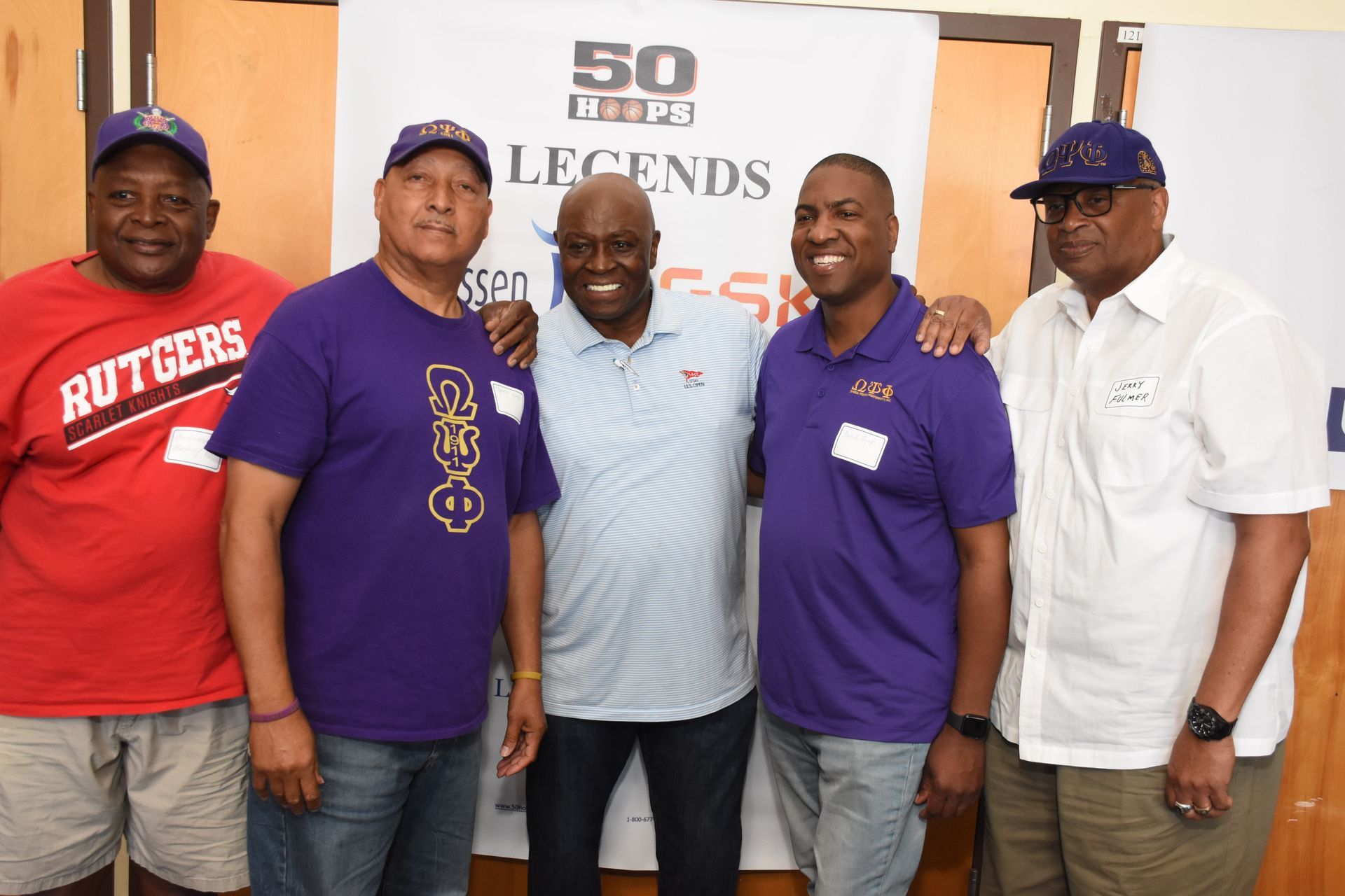 Five men standing together. 