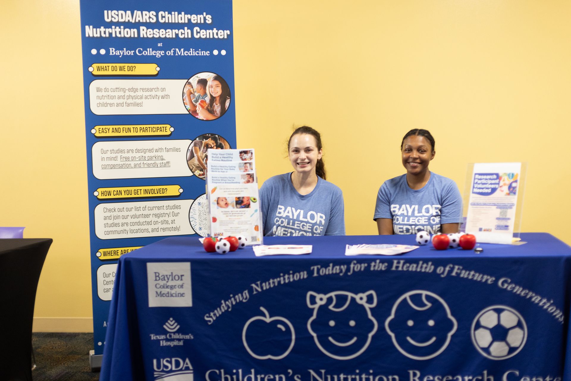 Two women at a booth with 
