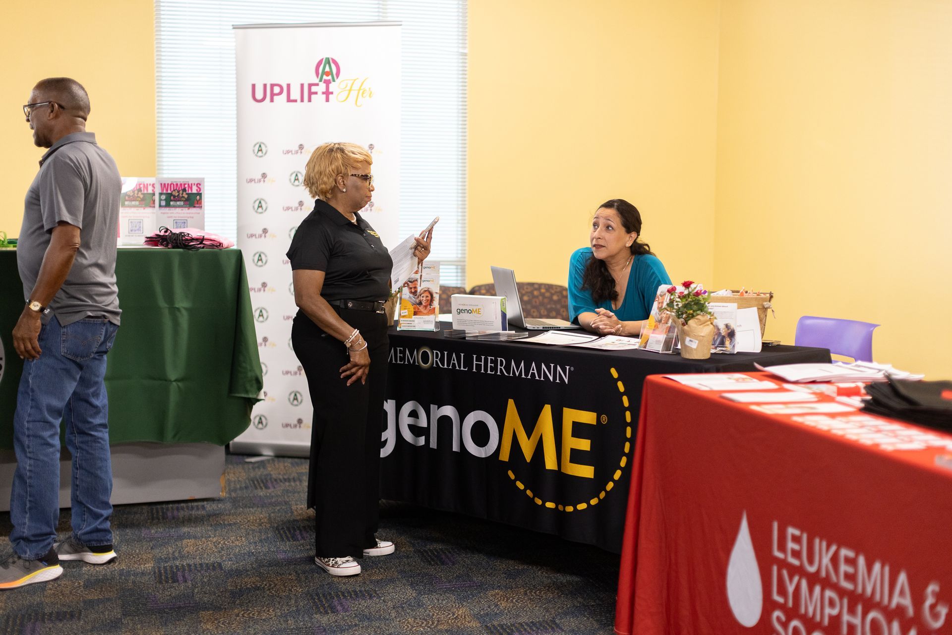 People at health fair. Woman talking at 