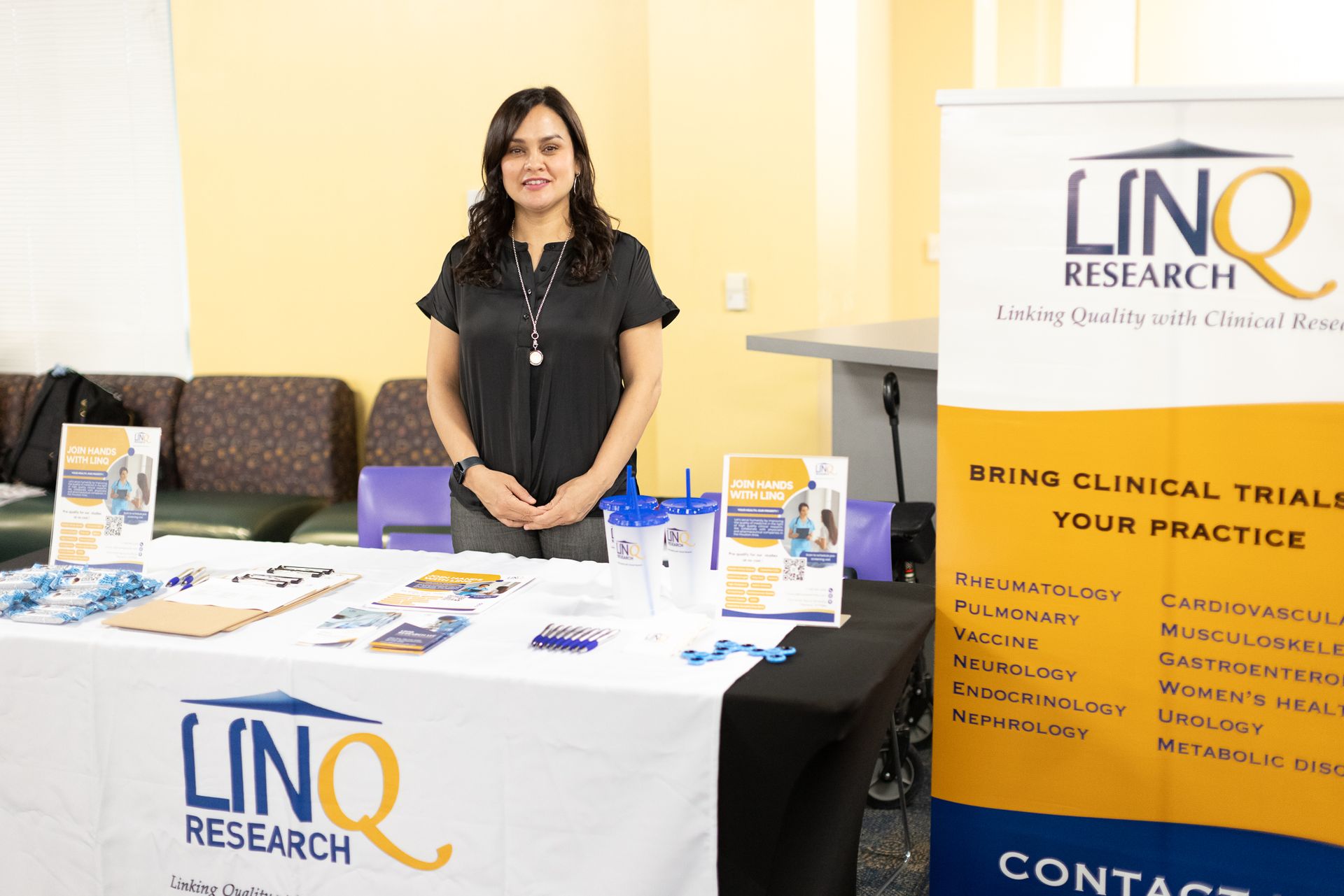 Woman stands at a table with 