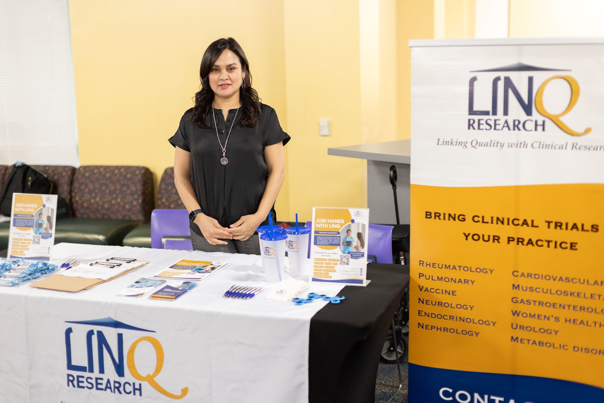 Woman stands at a table with a 