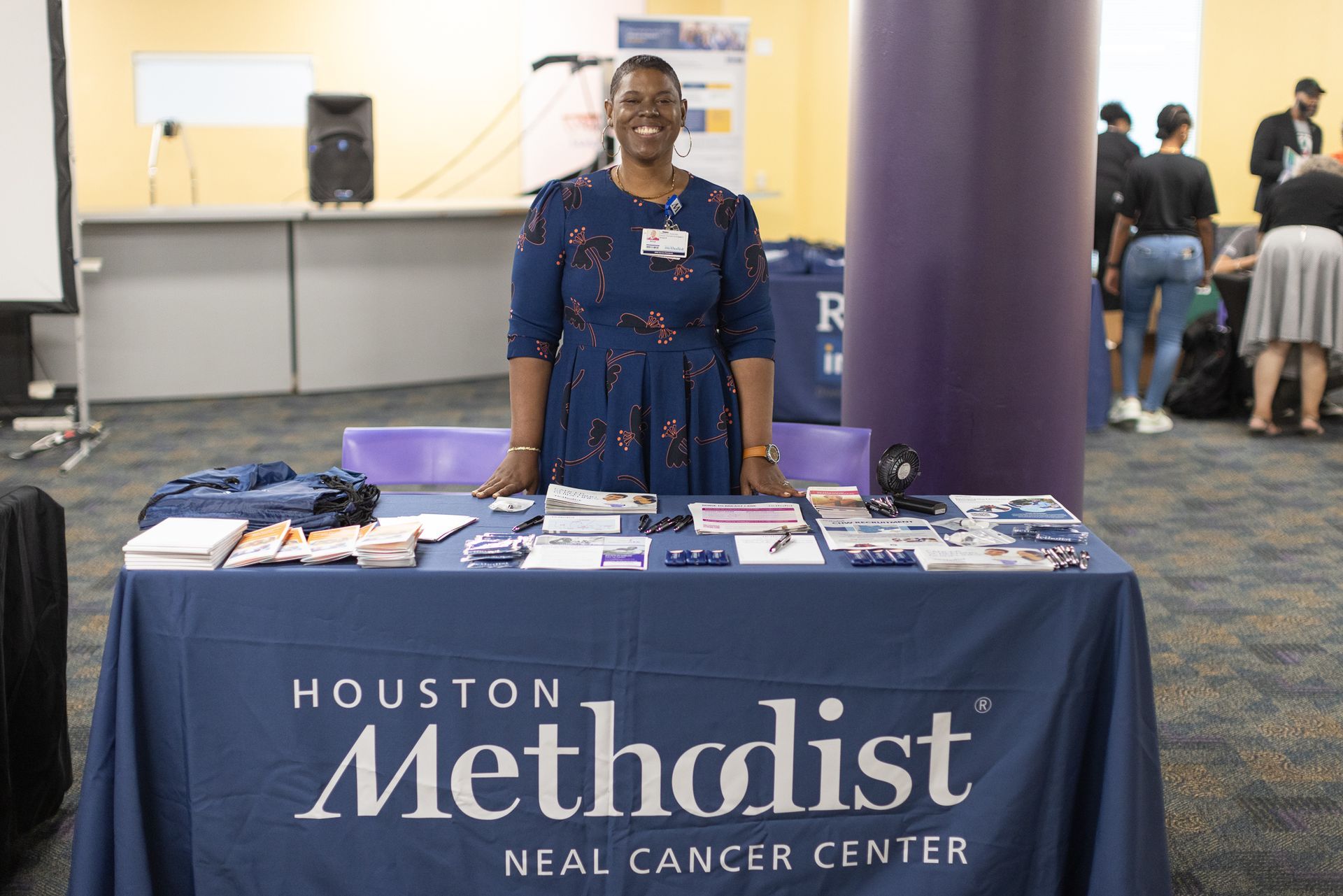 Woman at a Houston Methodist Real Cancer Center table. 