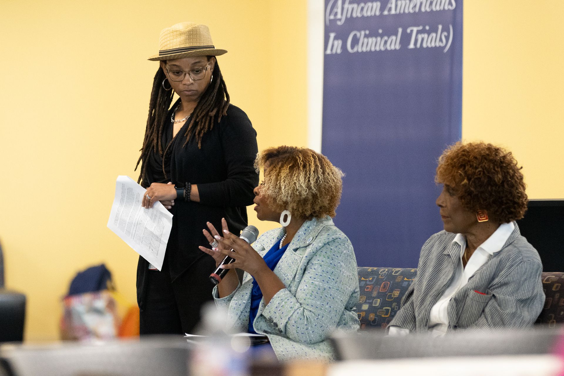 Three women participate in a panel discussion.