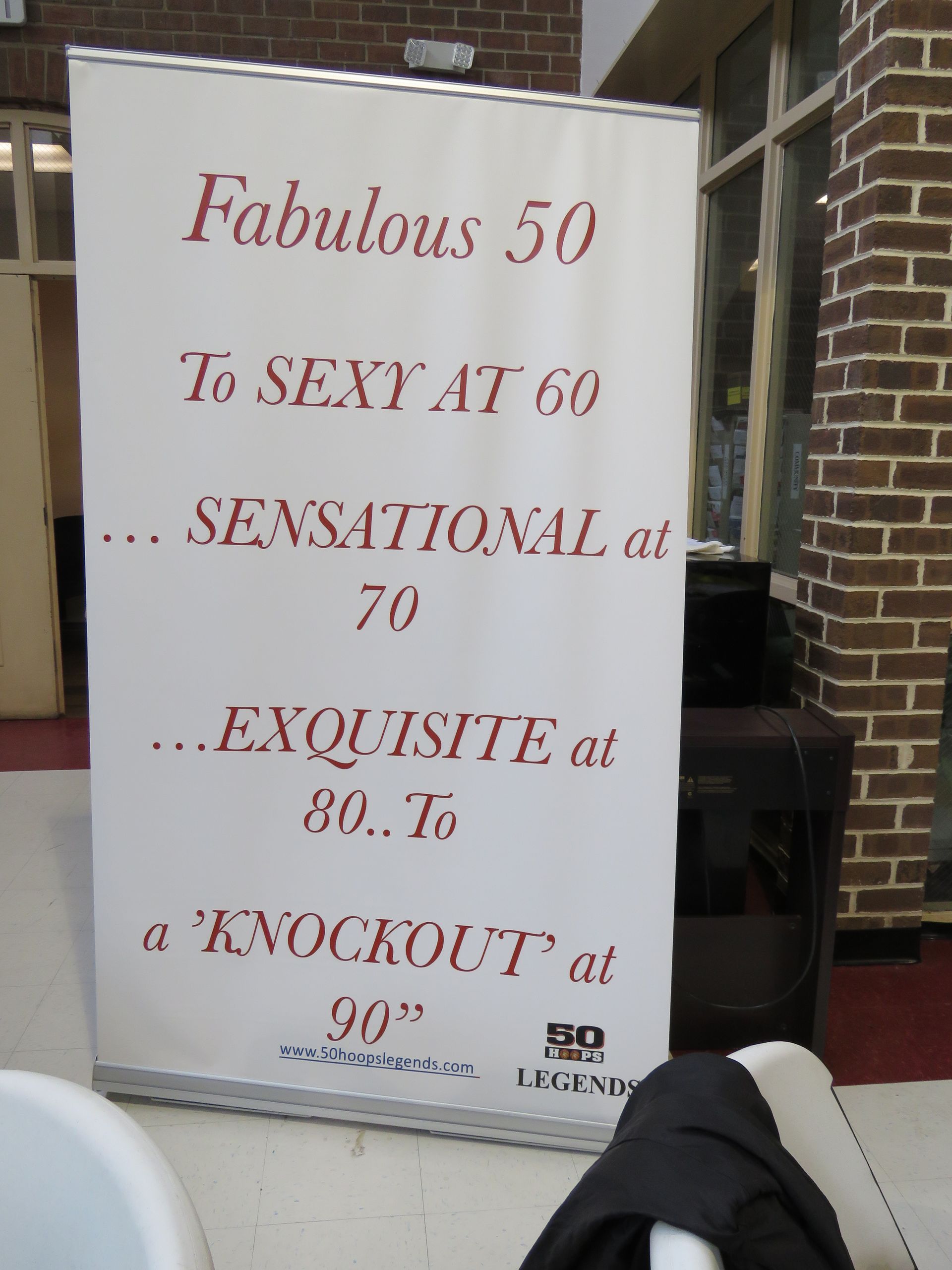 A roll-up banner with red text: 