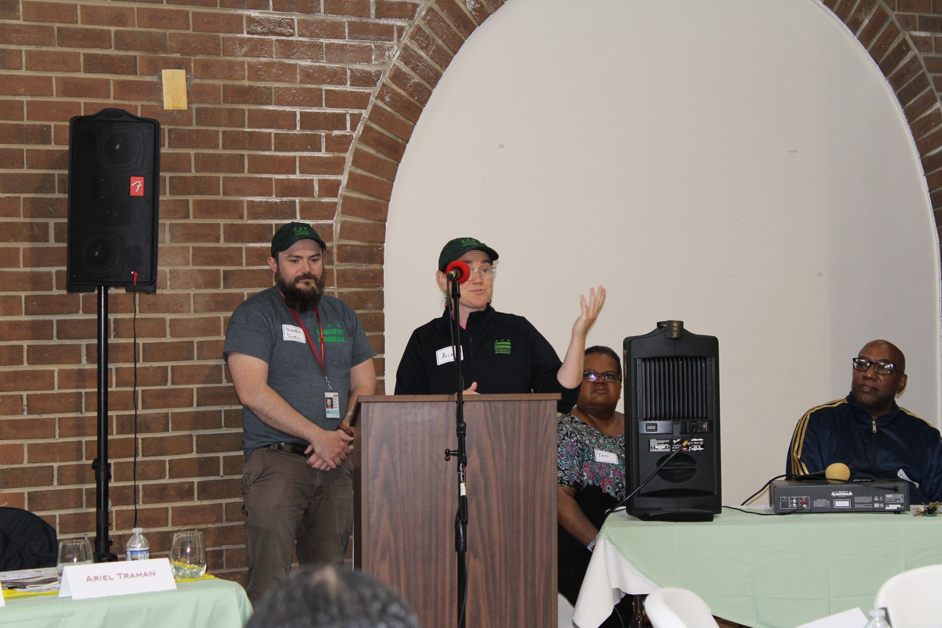 Two people speaking at a podium.