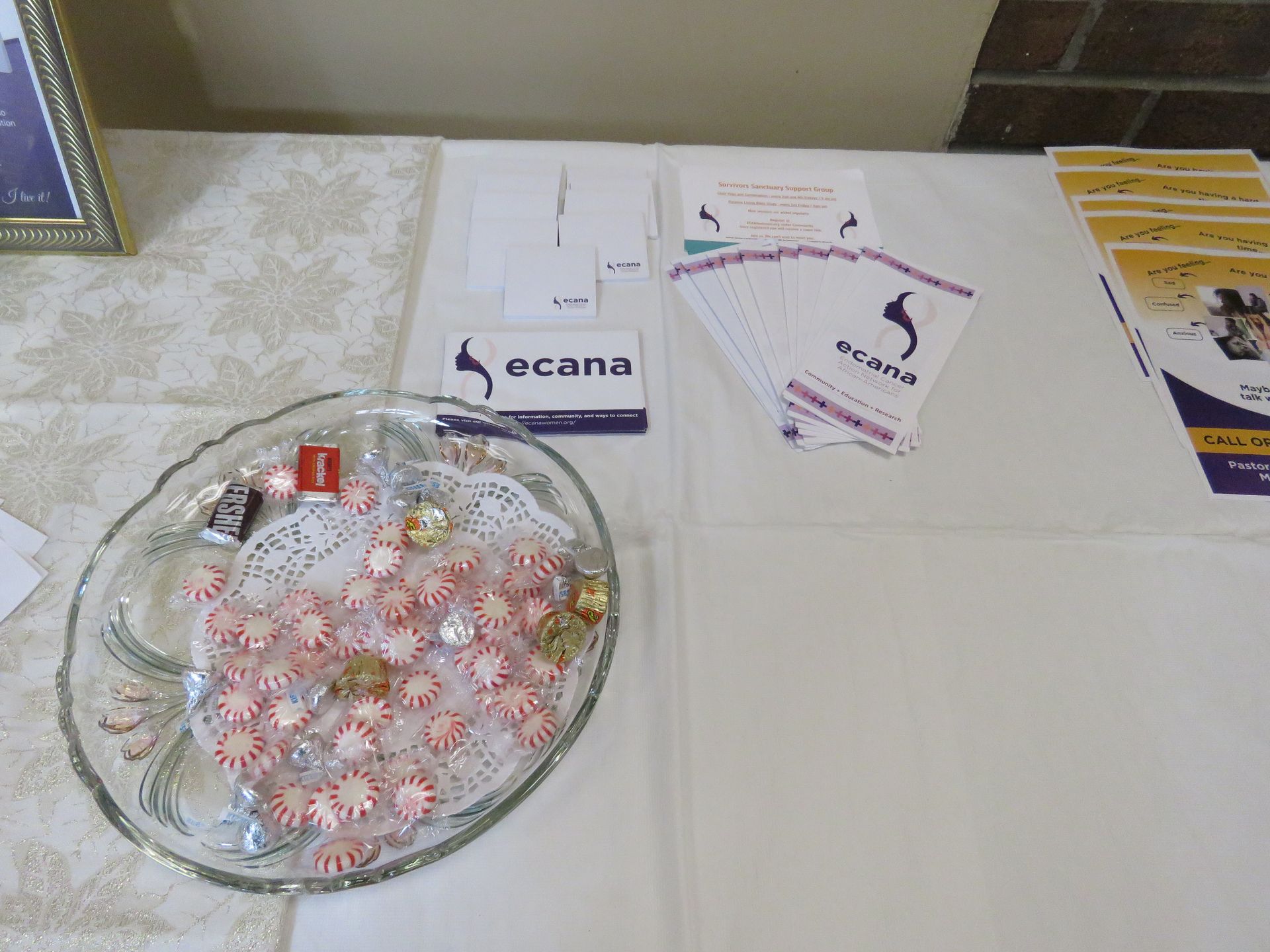 Table with mints, company brochures, and a sign that says 