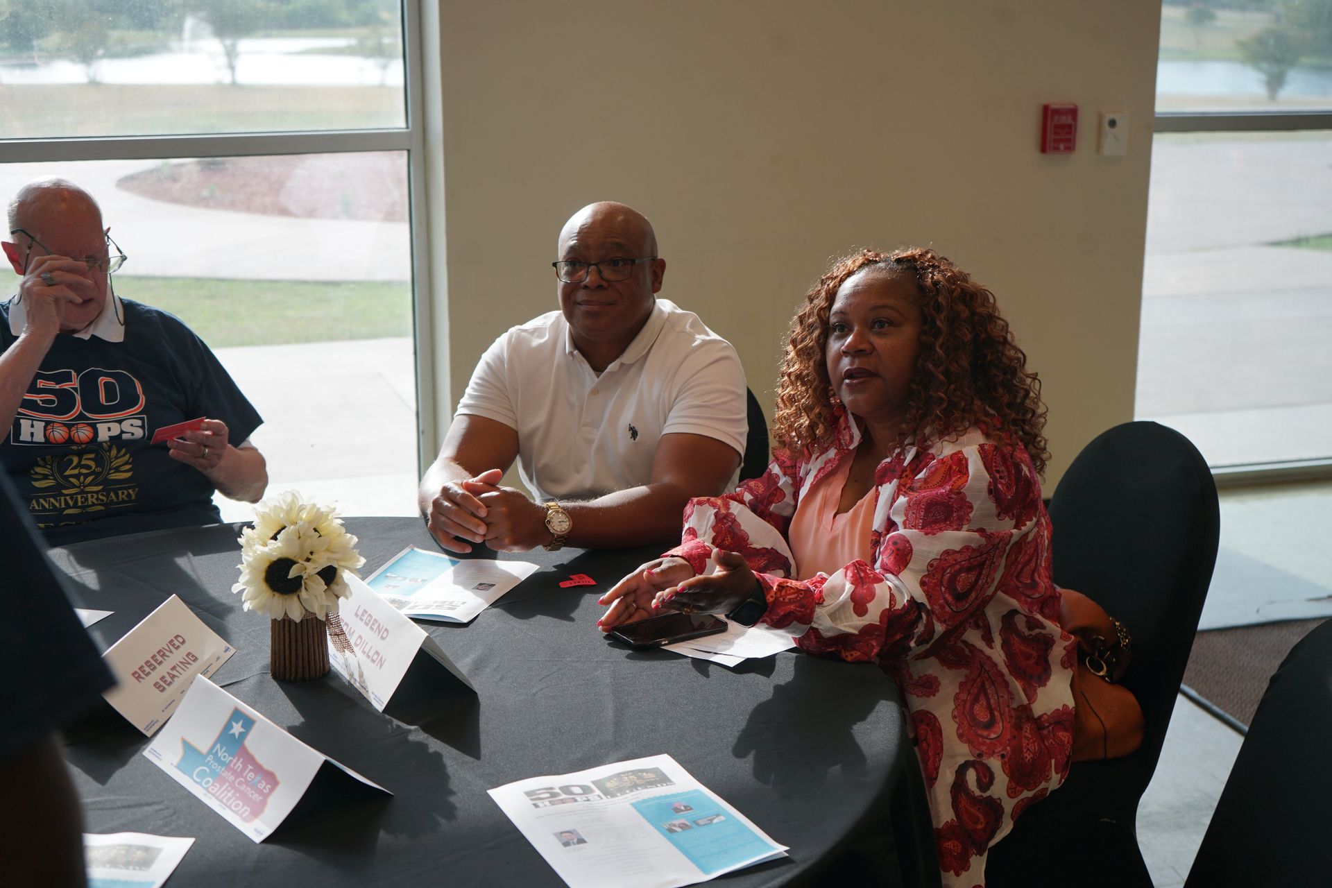 Three people seated at a round table
