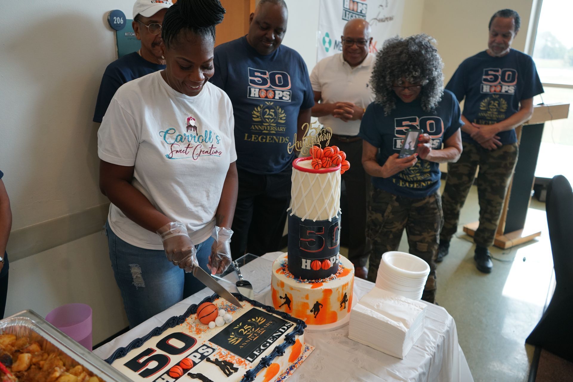 People celebrating with a two-tiered cake with 