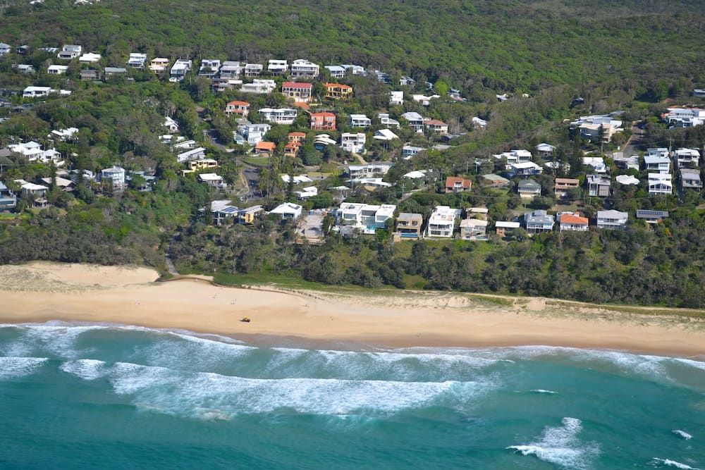 An Aerial View of a Beach and a Residential Area — Noosa Tree Stump Removal in Peregian Beach, QLD